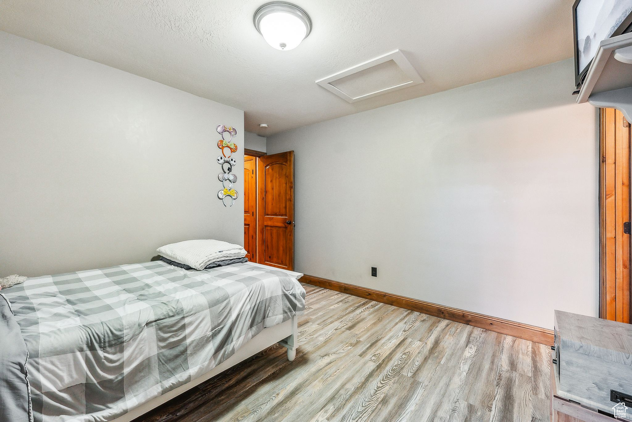 Bedroom with light hardwood / wood-style flooring