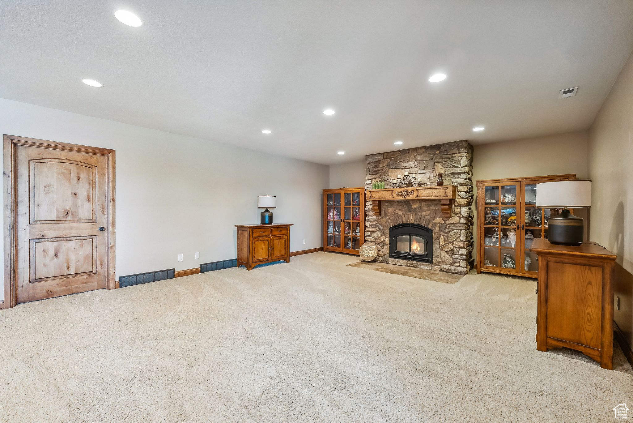 Carpeted living room with a fireplace