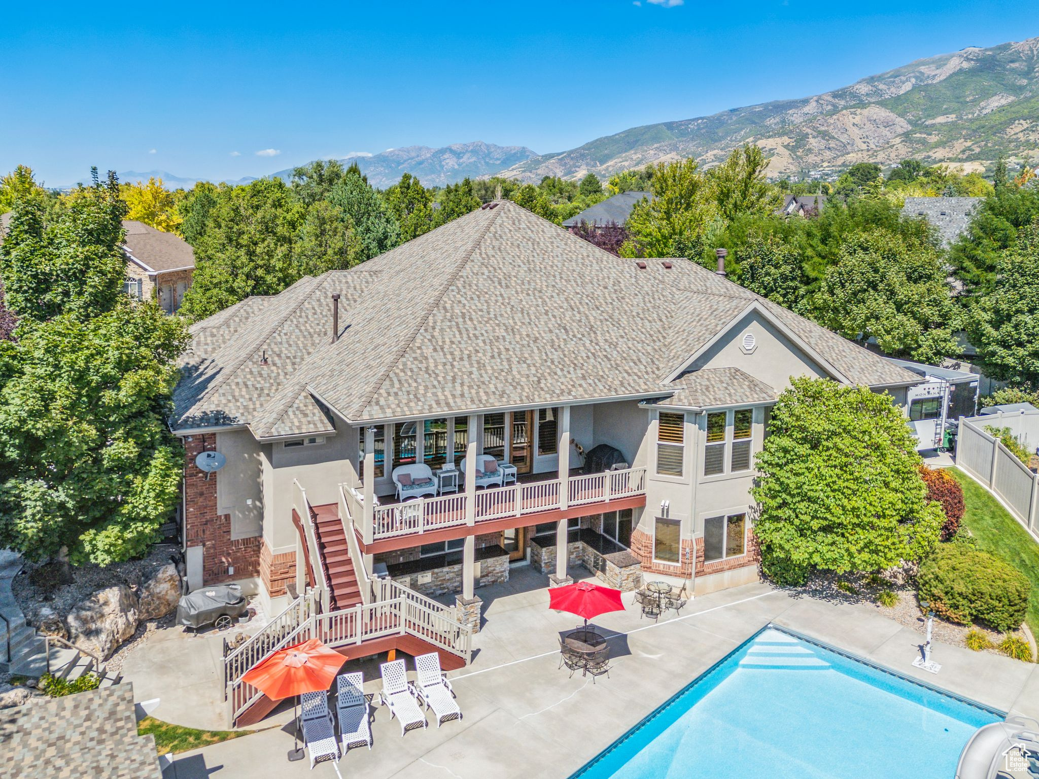 Rear view of property featuring a mountain view and a patio area