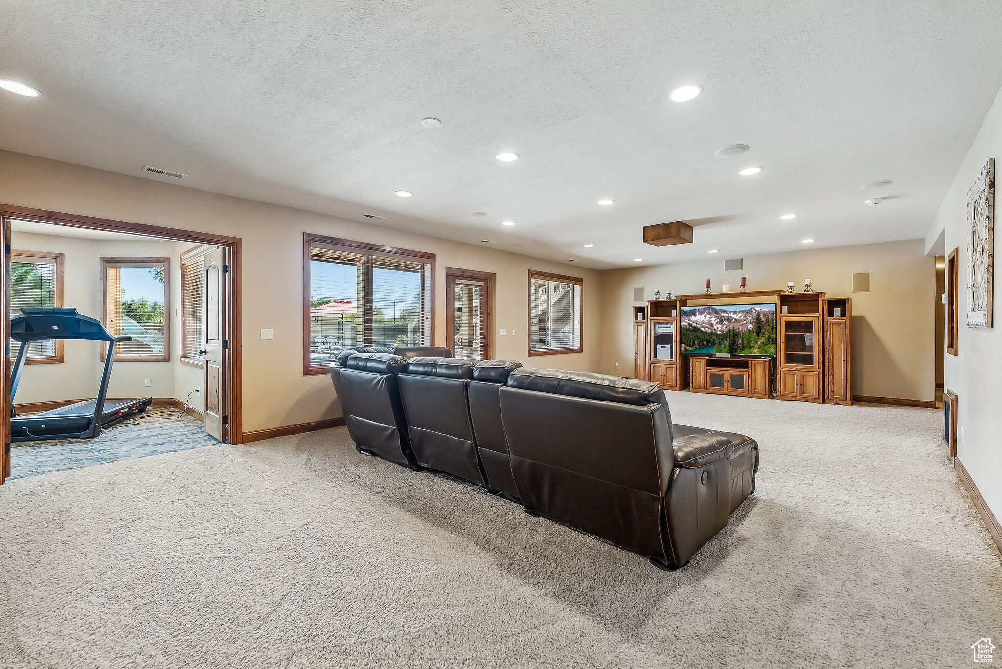 Living room featuring light carpet and a textured ceiling