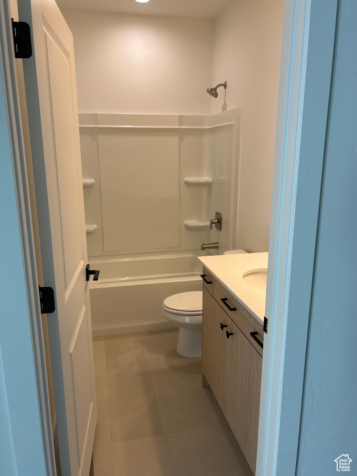 Upstairs Full bathroom with vanity, toilet,  shower combination, and tile patterned floors