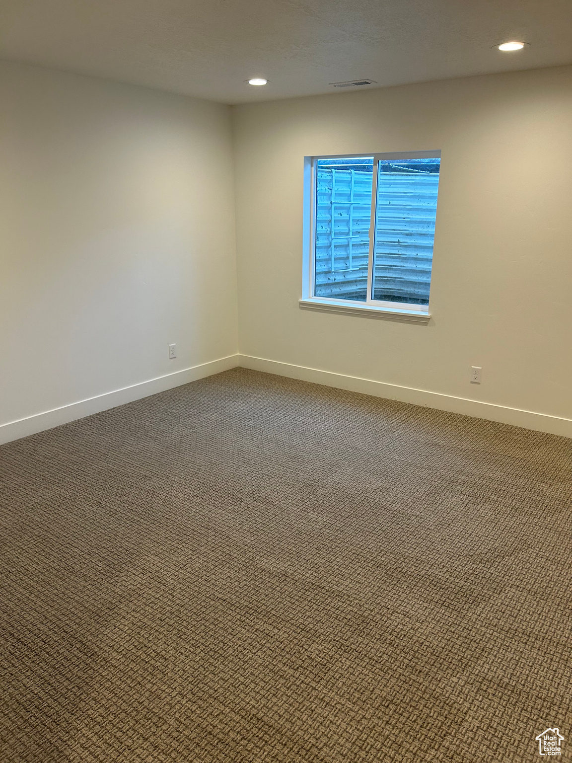 Downstairs fully finished great room looking toward window