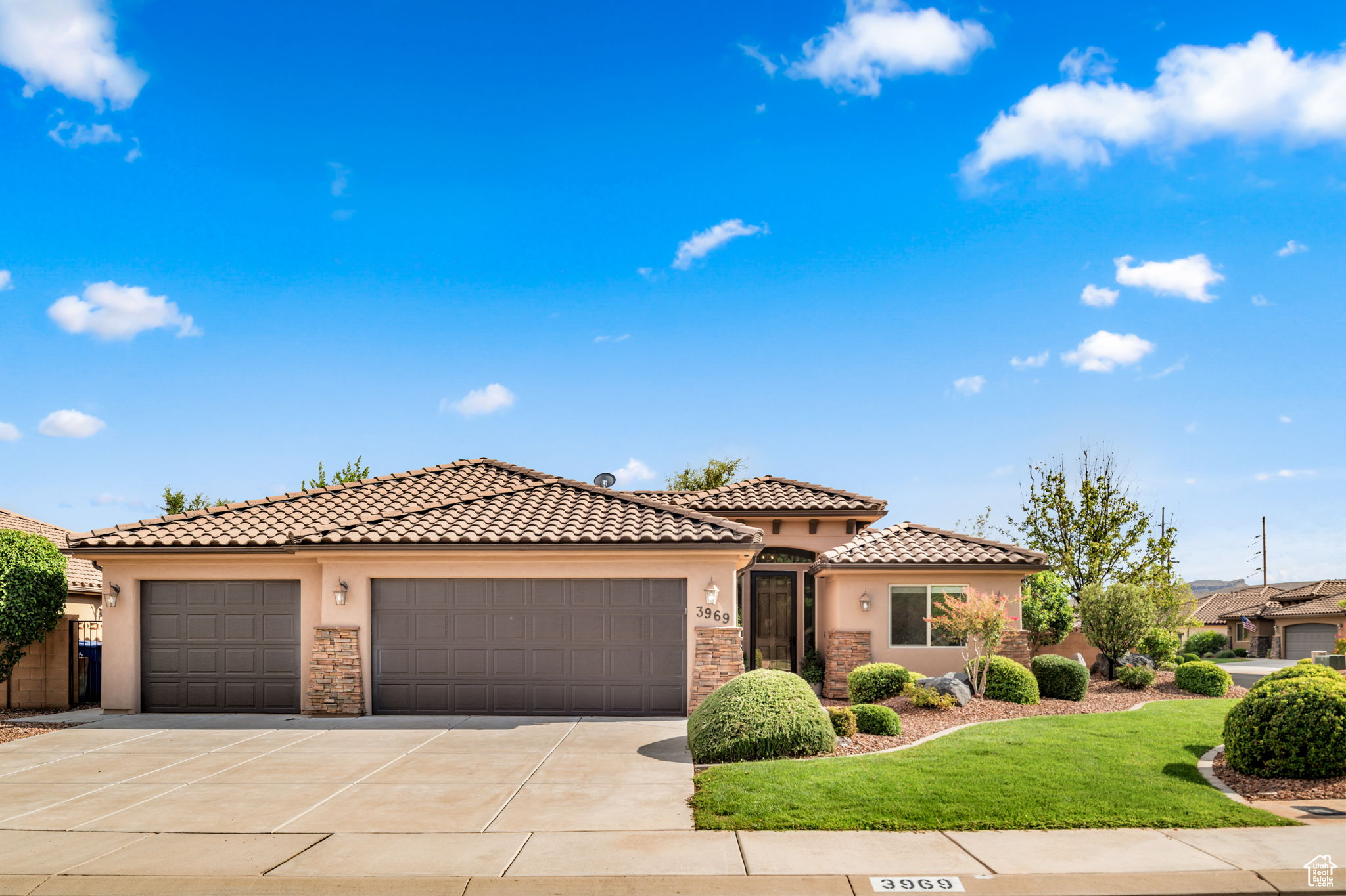 Mediterranean / spanish house featuring a garage and a front yard