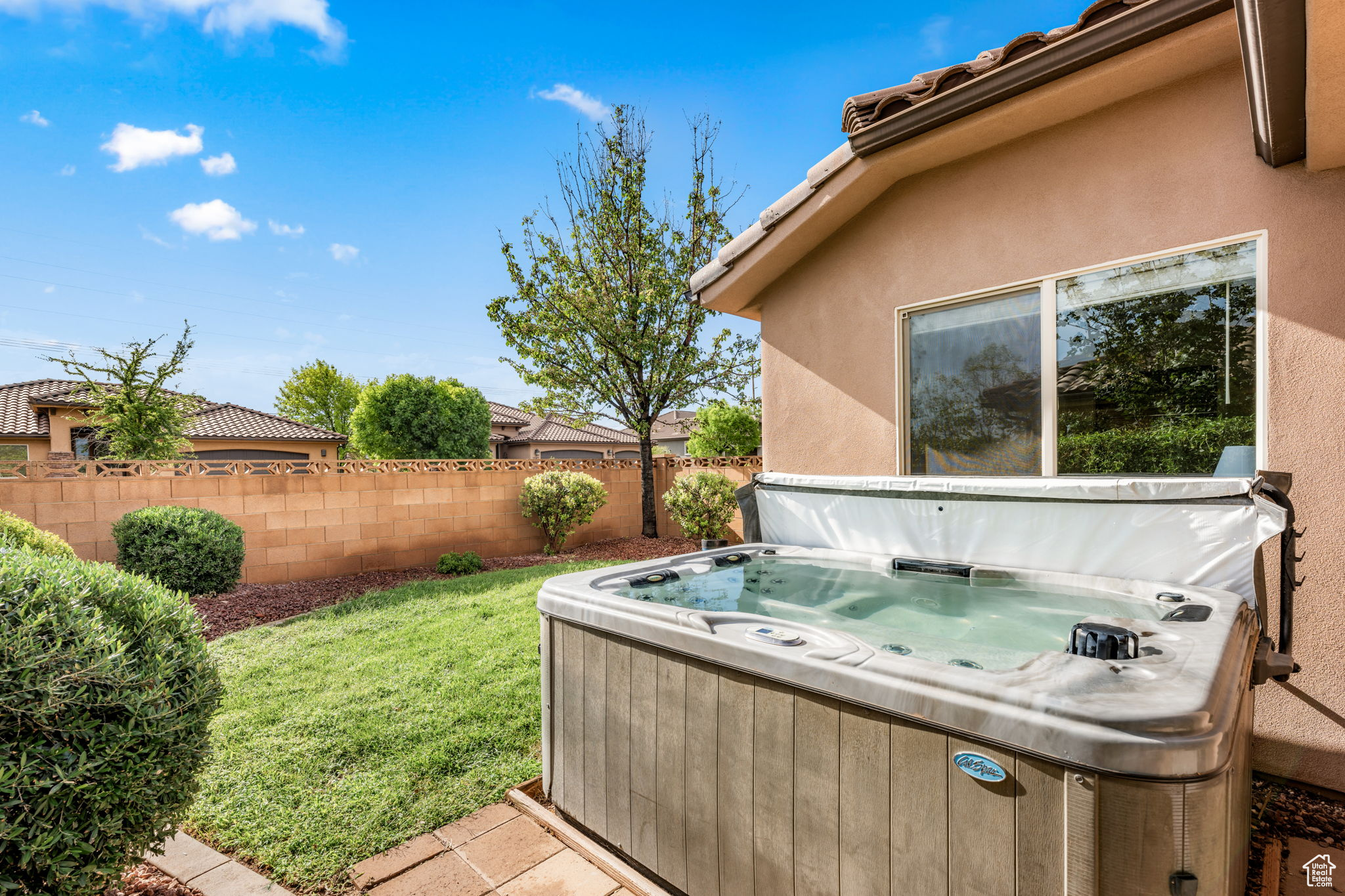 Exterior space with a hot tub