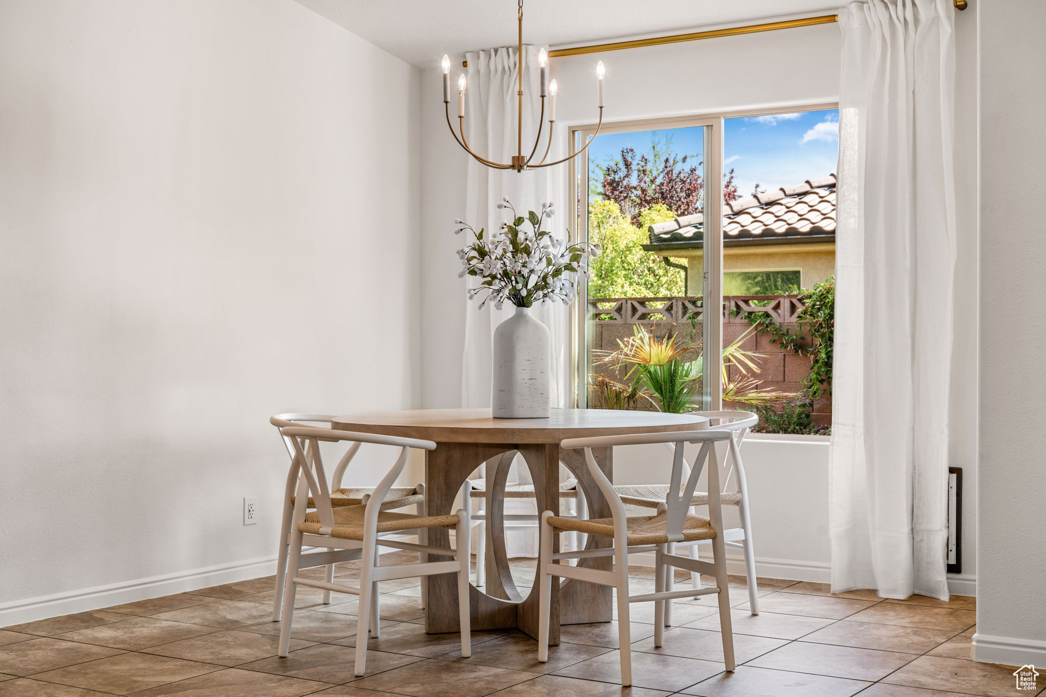 Tiled dining space with a chandelier