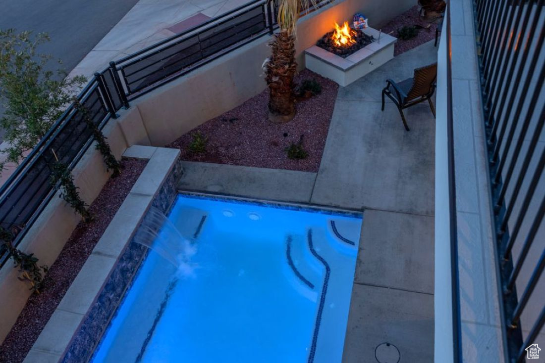 View of pool featuring a patio and an outdoor fire pit