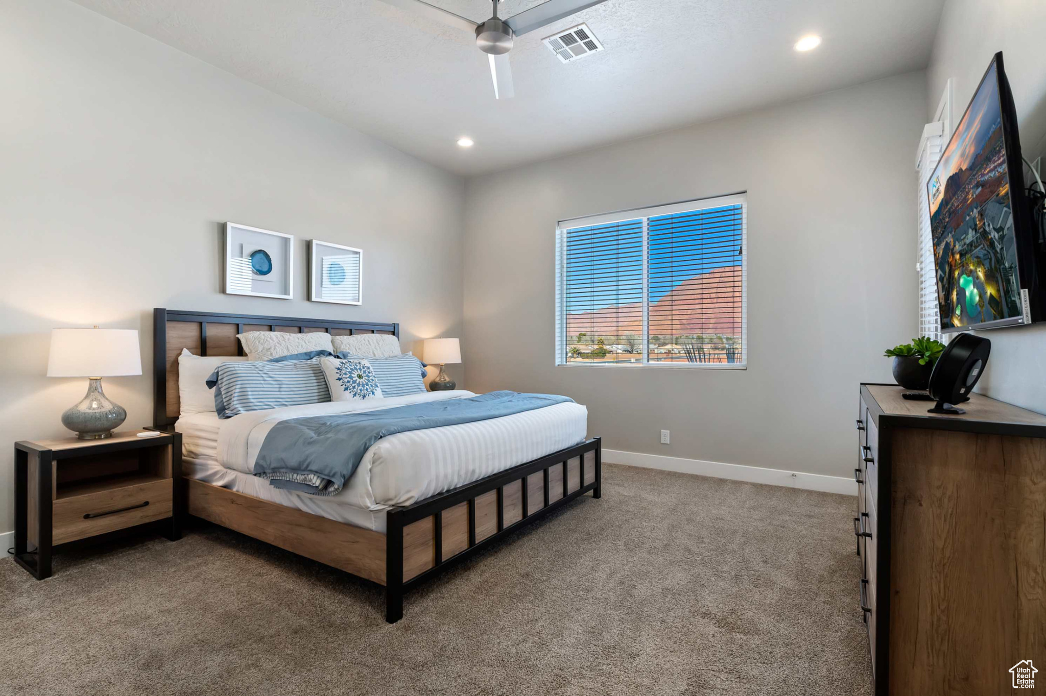 Bedroom with ceiling fan and light carpet