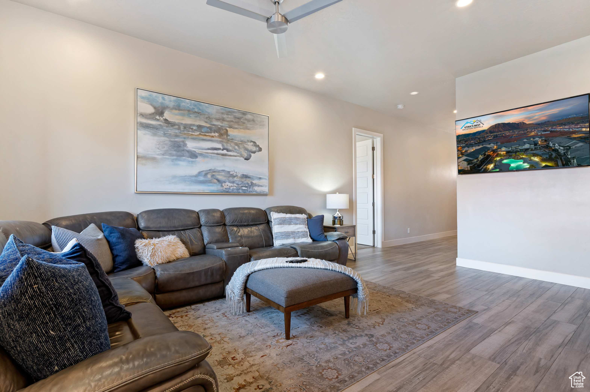 Living room featuring hardwood / wood-style flooring and ceiling fan