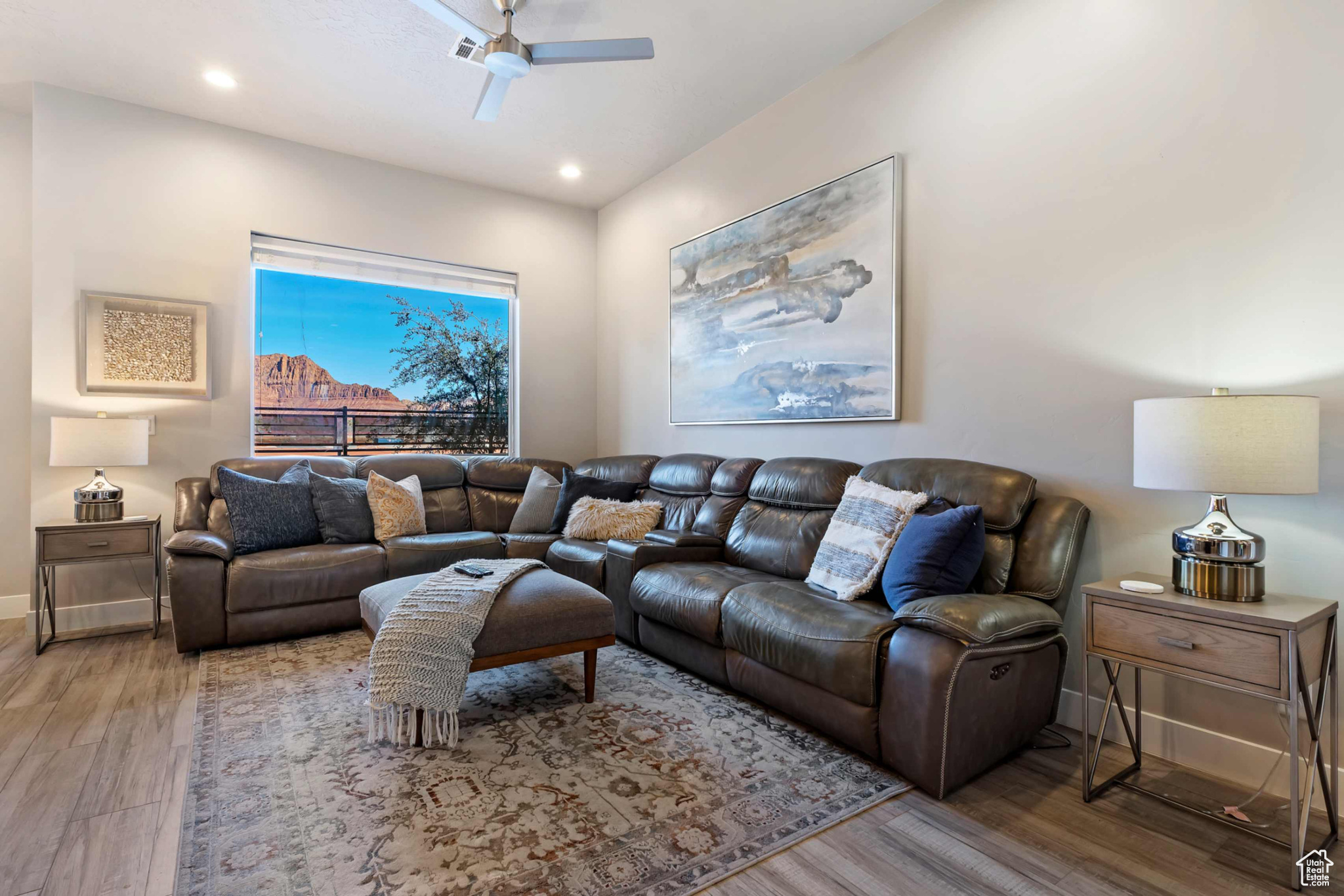 Living room featuring ceiling fan and hardwood / wood-style floors