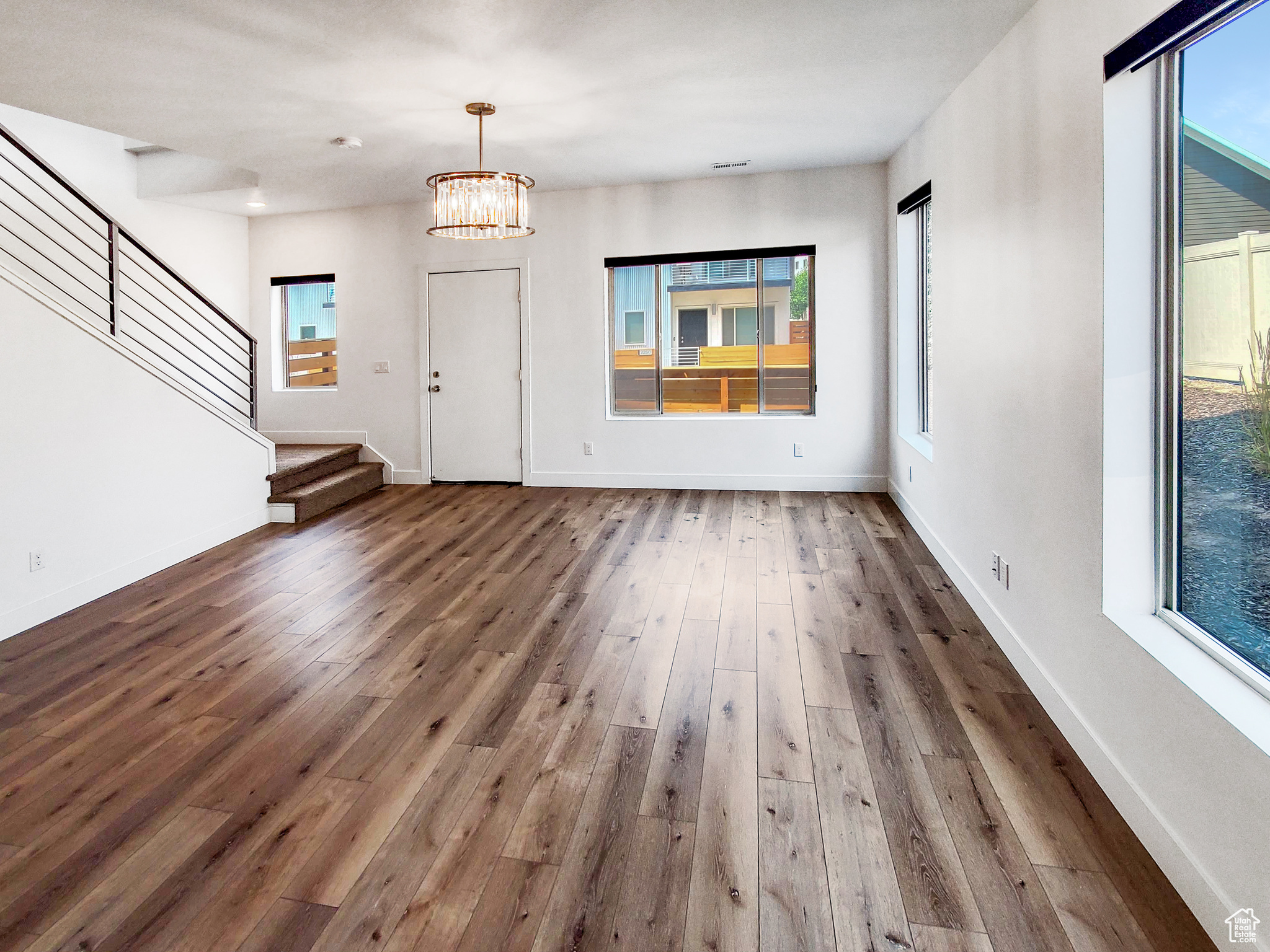 Entryway featuring hardwood / wood-style flooring, plenty of natural light, and an inviting chandelier