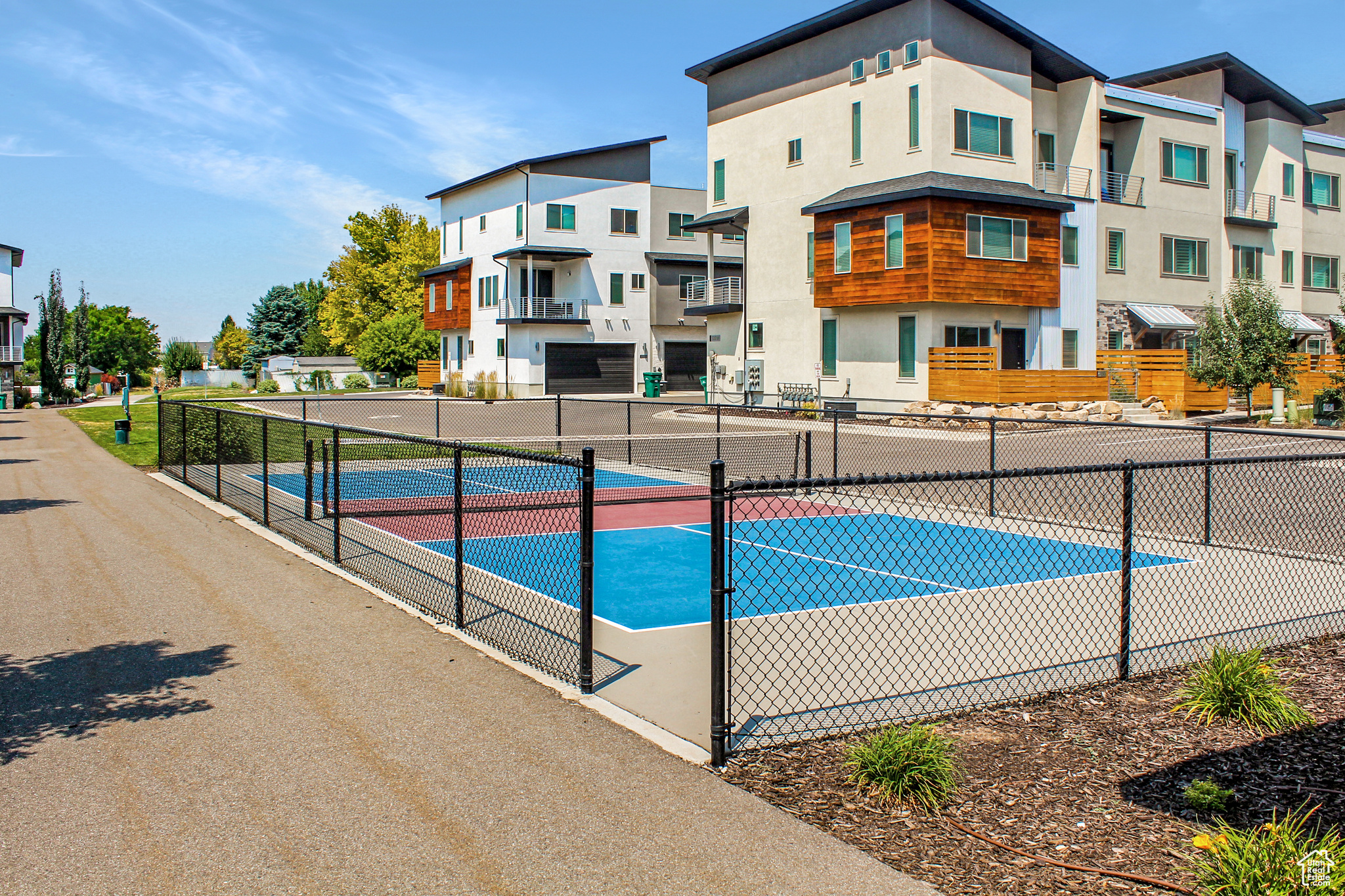 View of pool featuring tennis court