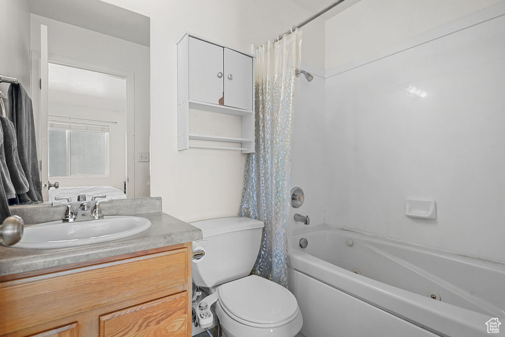 Full bathroom with vanity, toilet, and shower / tub combo