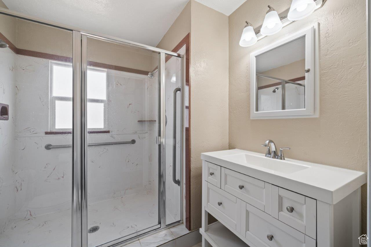 Bathroom with vanity and an enclosed shower