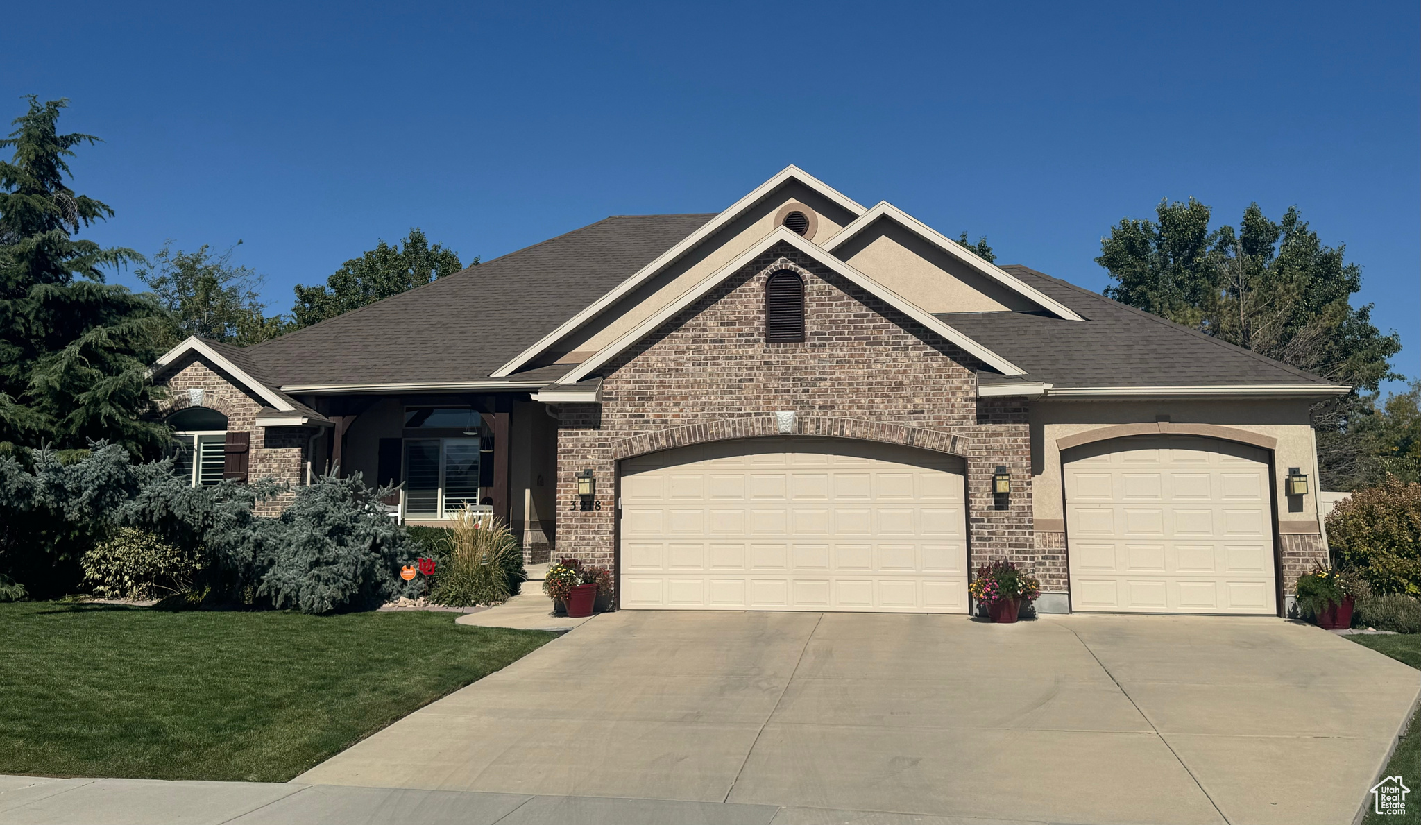 Craftsman-style house with a garage and a front lawn