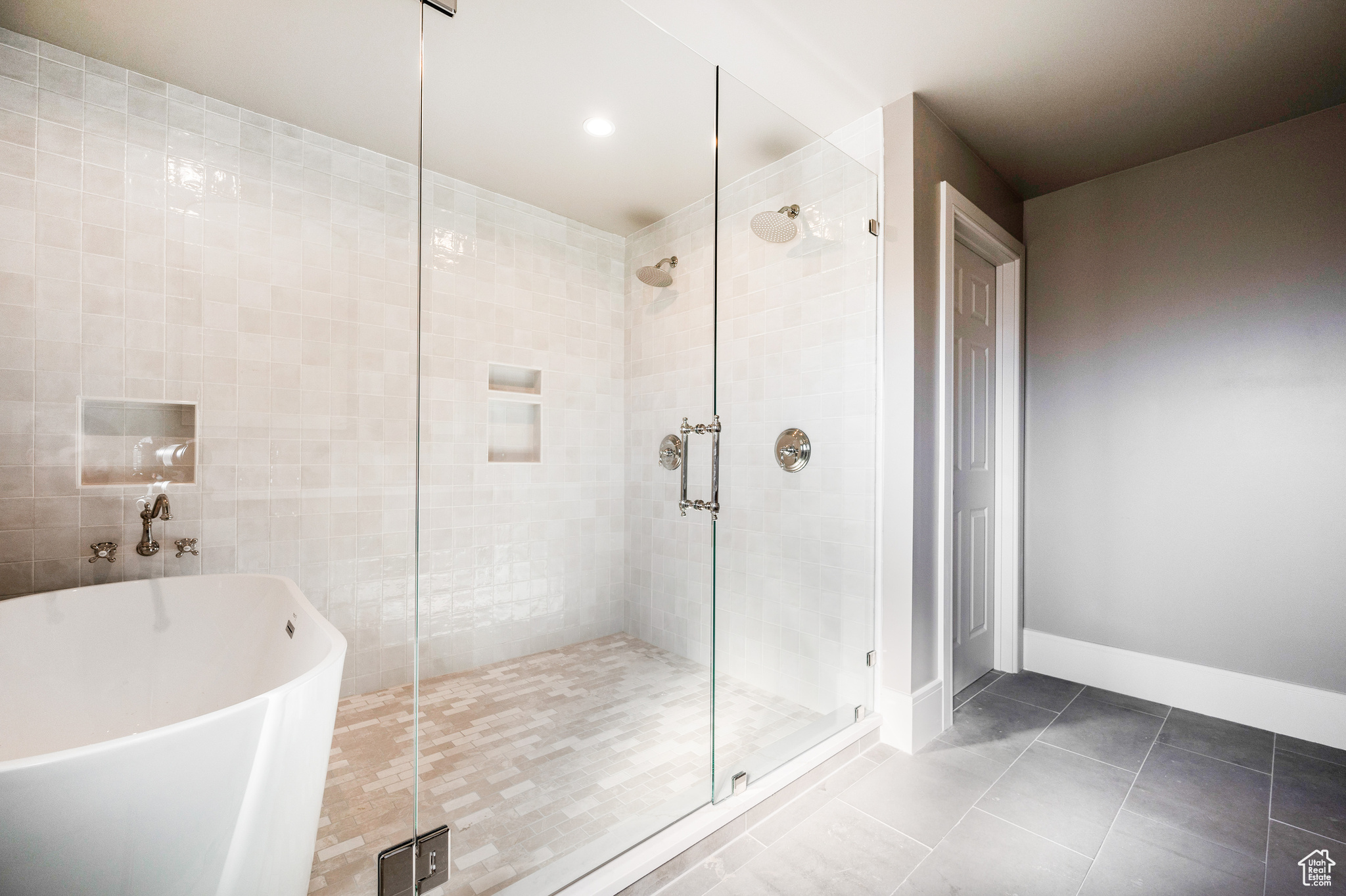 Bathroom with independent shower and bath and tile patterned floors