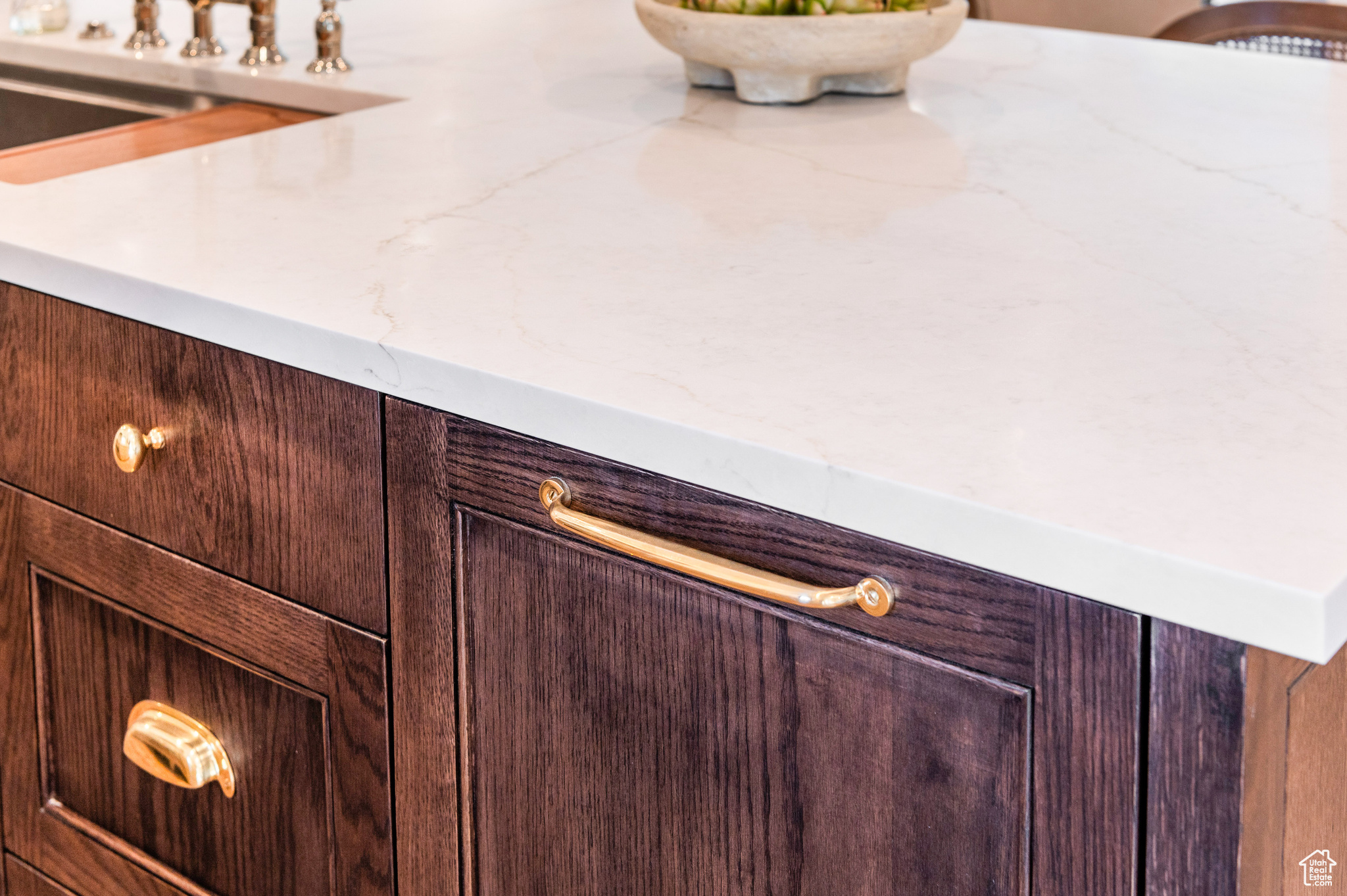 Interior details featuring dark brown cabinetry and light stone countertops