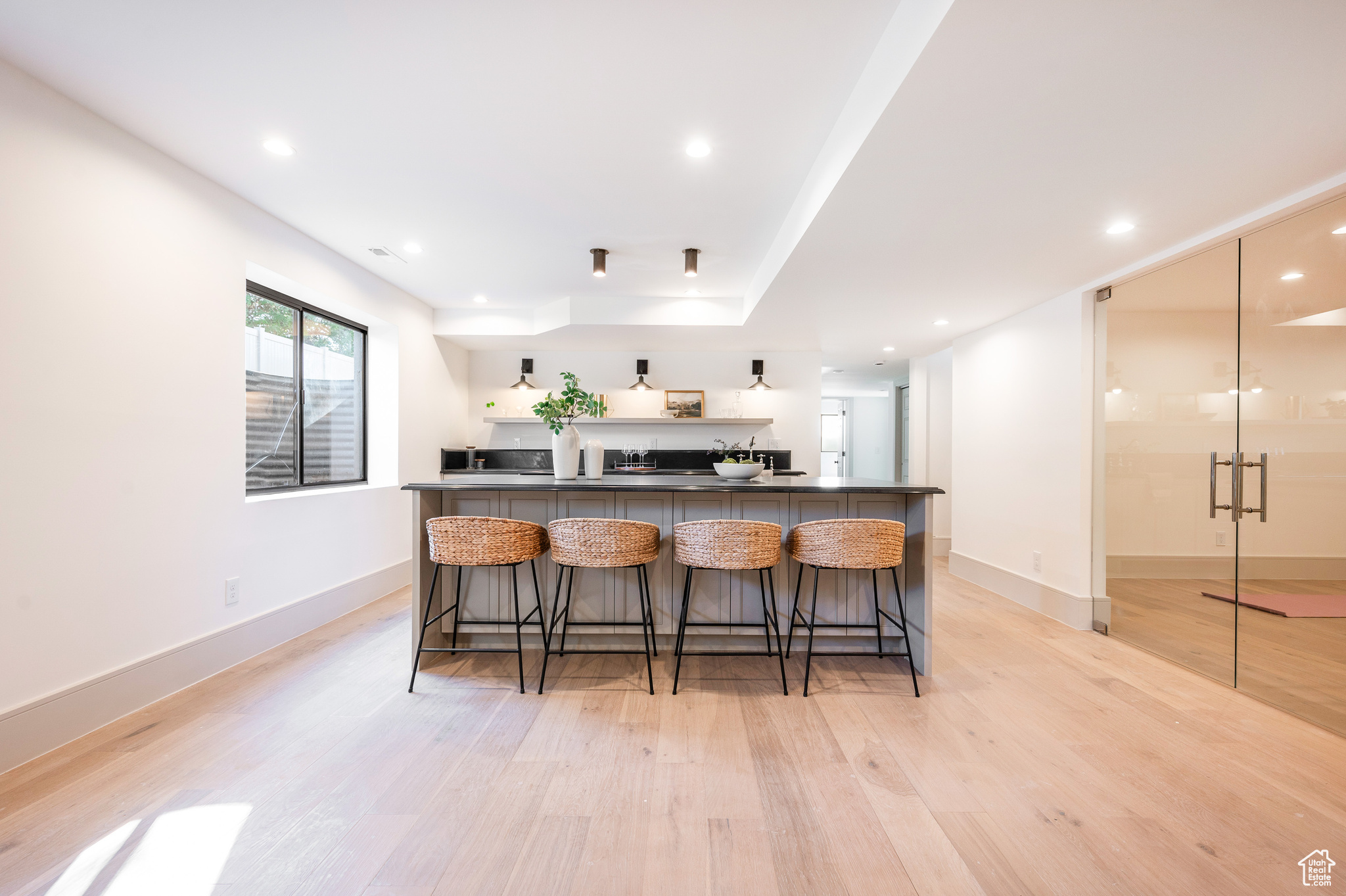 Kitchen featuring a kitchen breakfast bar and light hardwood / wood-style flooring