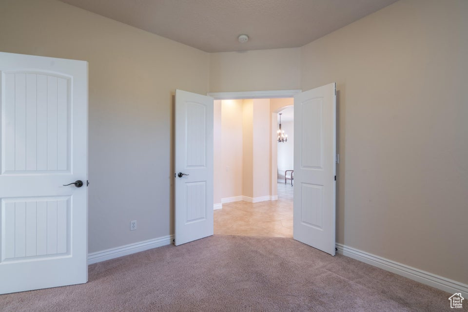 Unfurnished bedroom with light carpet