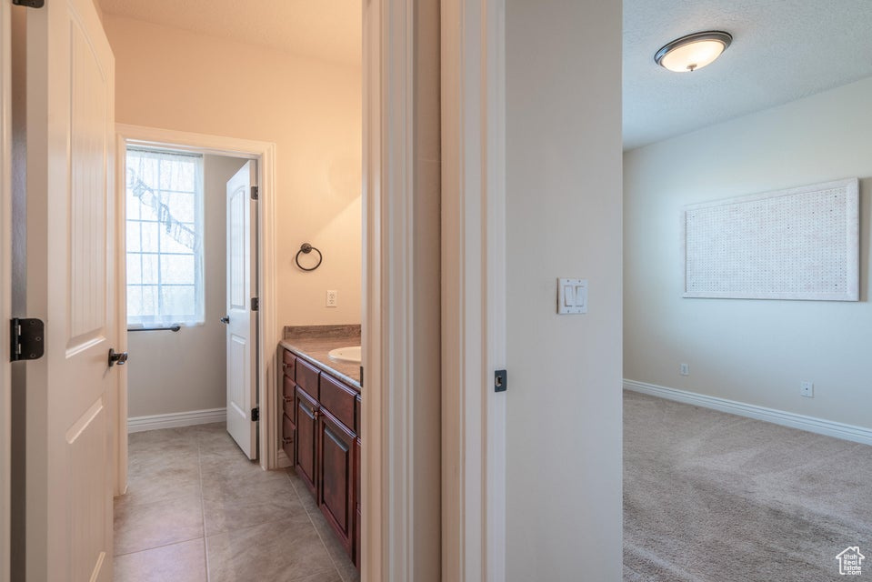 Bathroom featuring tile patterned floors and vanity