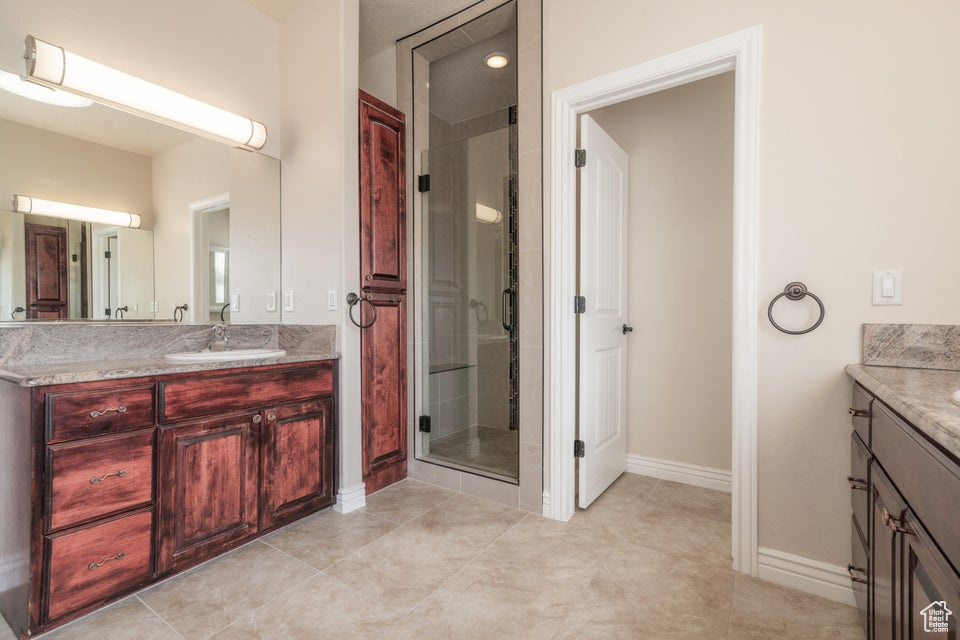 Bathroom with a shower with shower door and vanity