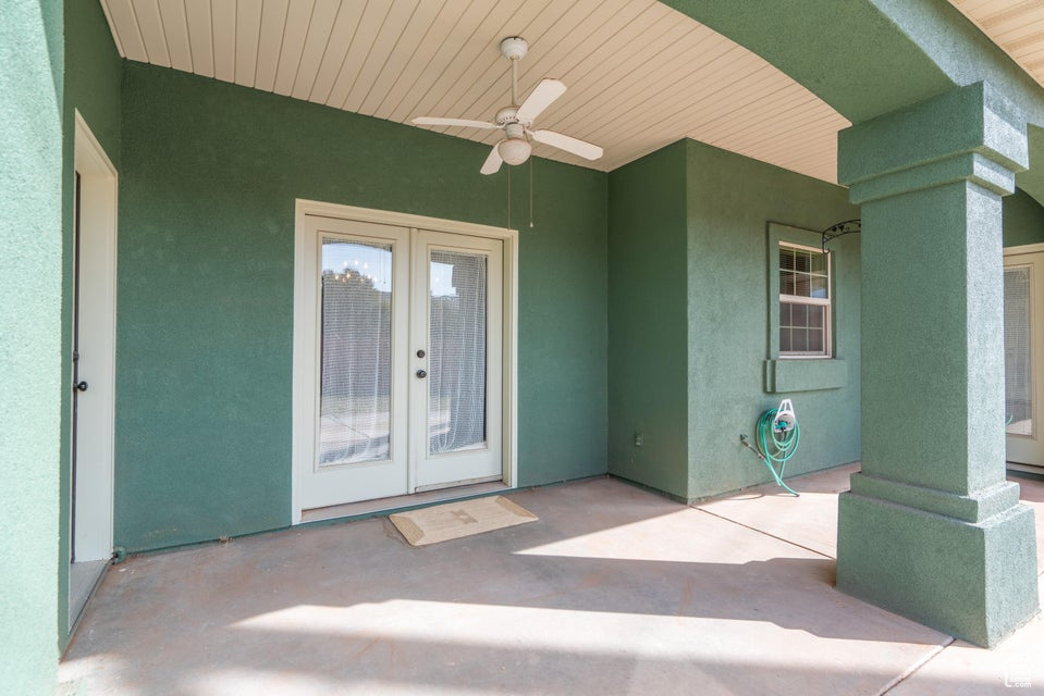 Property entrance with ceiling fan, a patio, and french doors