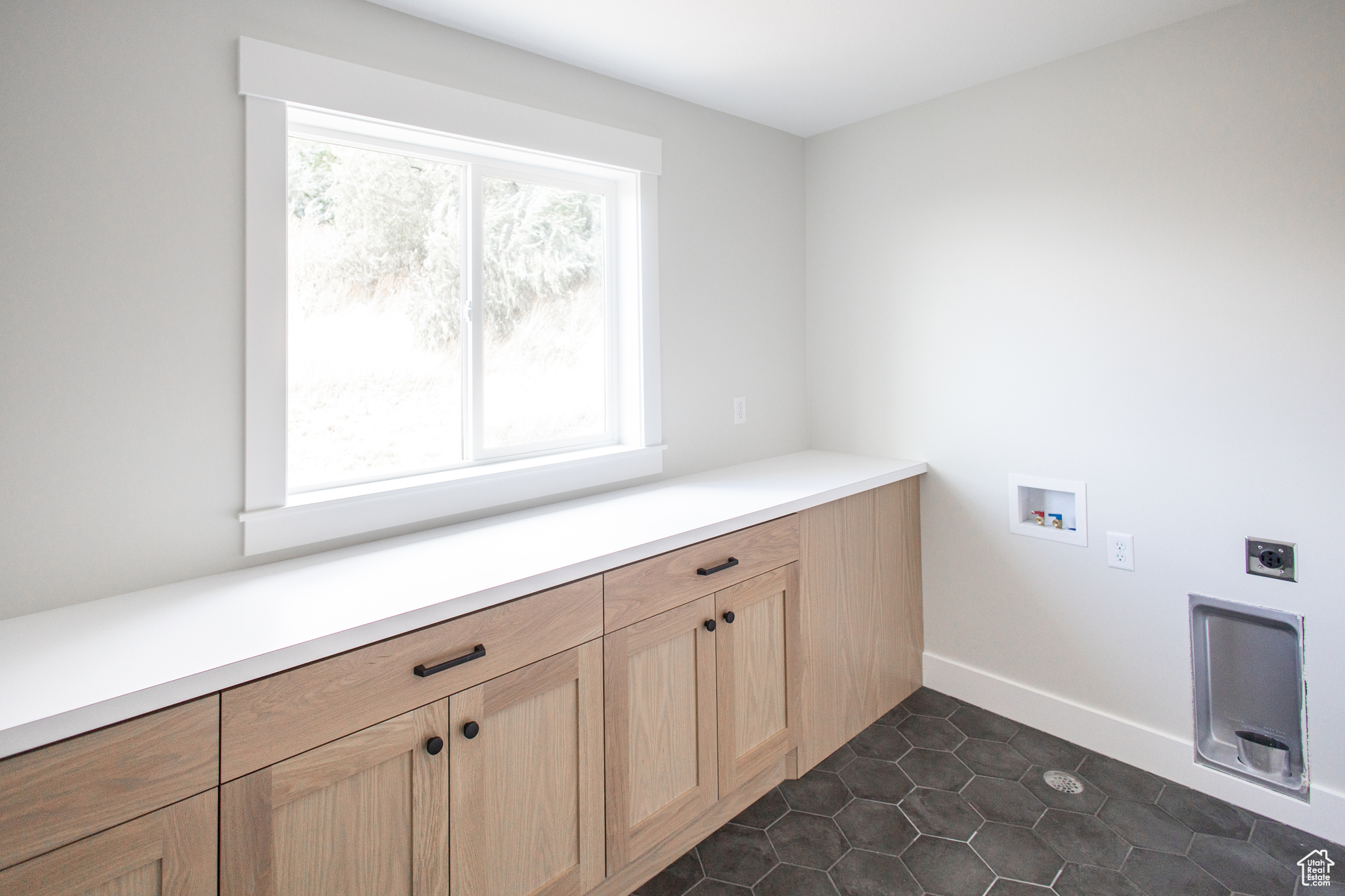 Large Laundry Room with plenty of cabinet and countertop space.