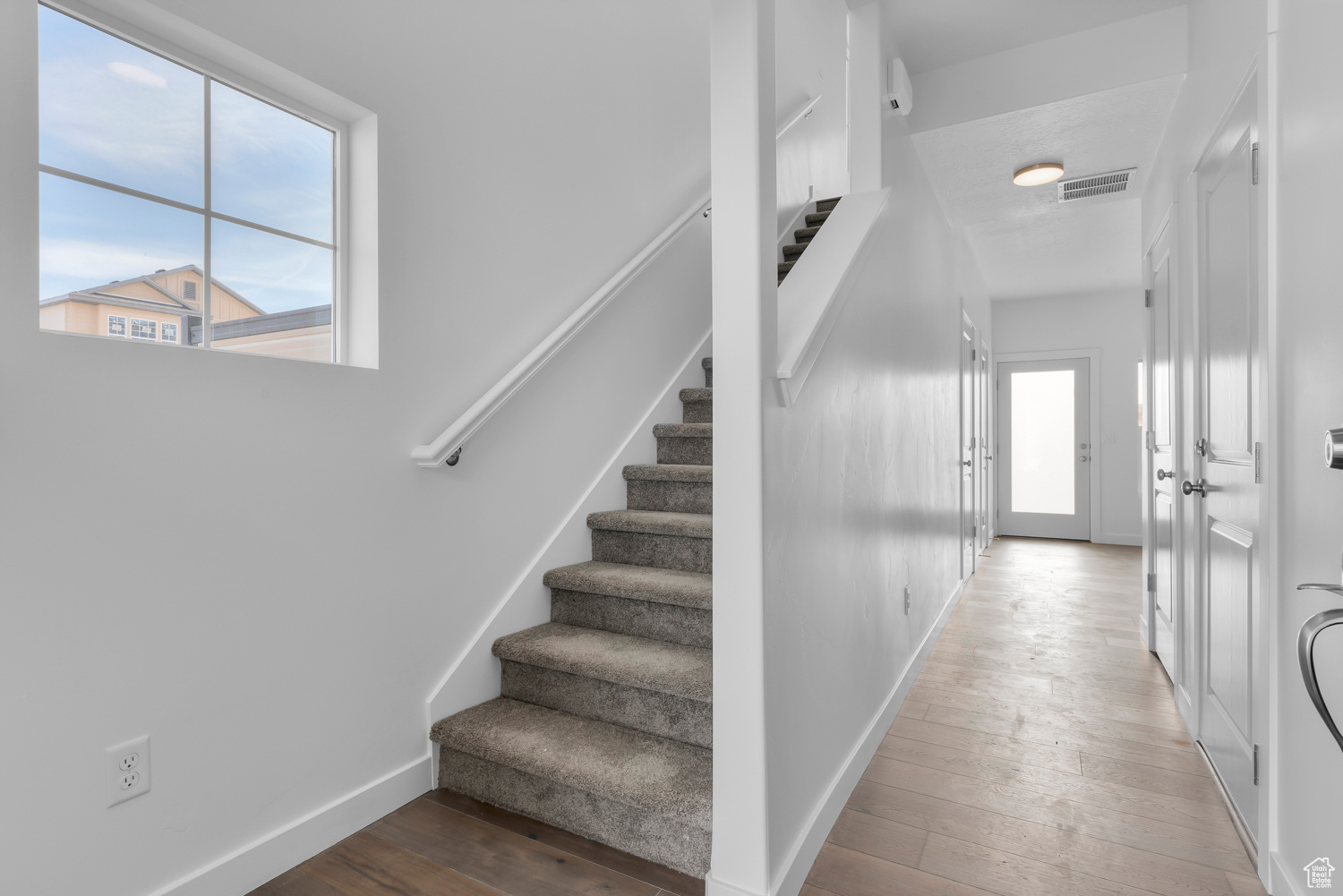 Staircase featuring hardwood / wood-style floors