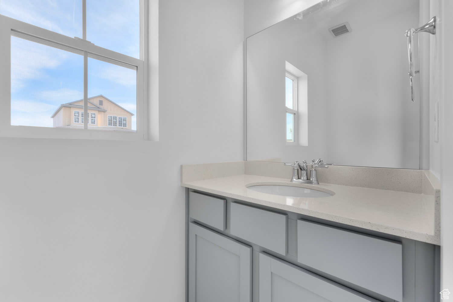 Bathroom with vanity and a wealth of natural light