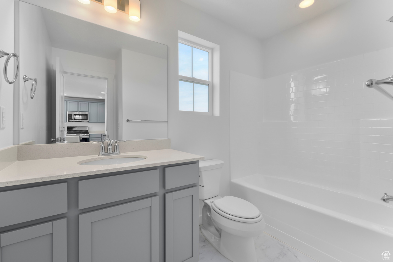 Full bathroom featuring vanity, shower / bathtub combination, and toilet