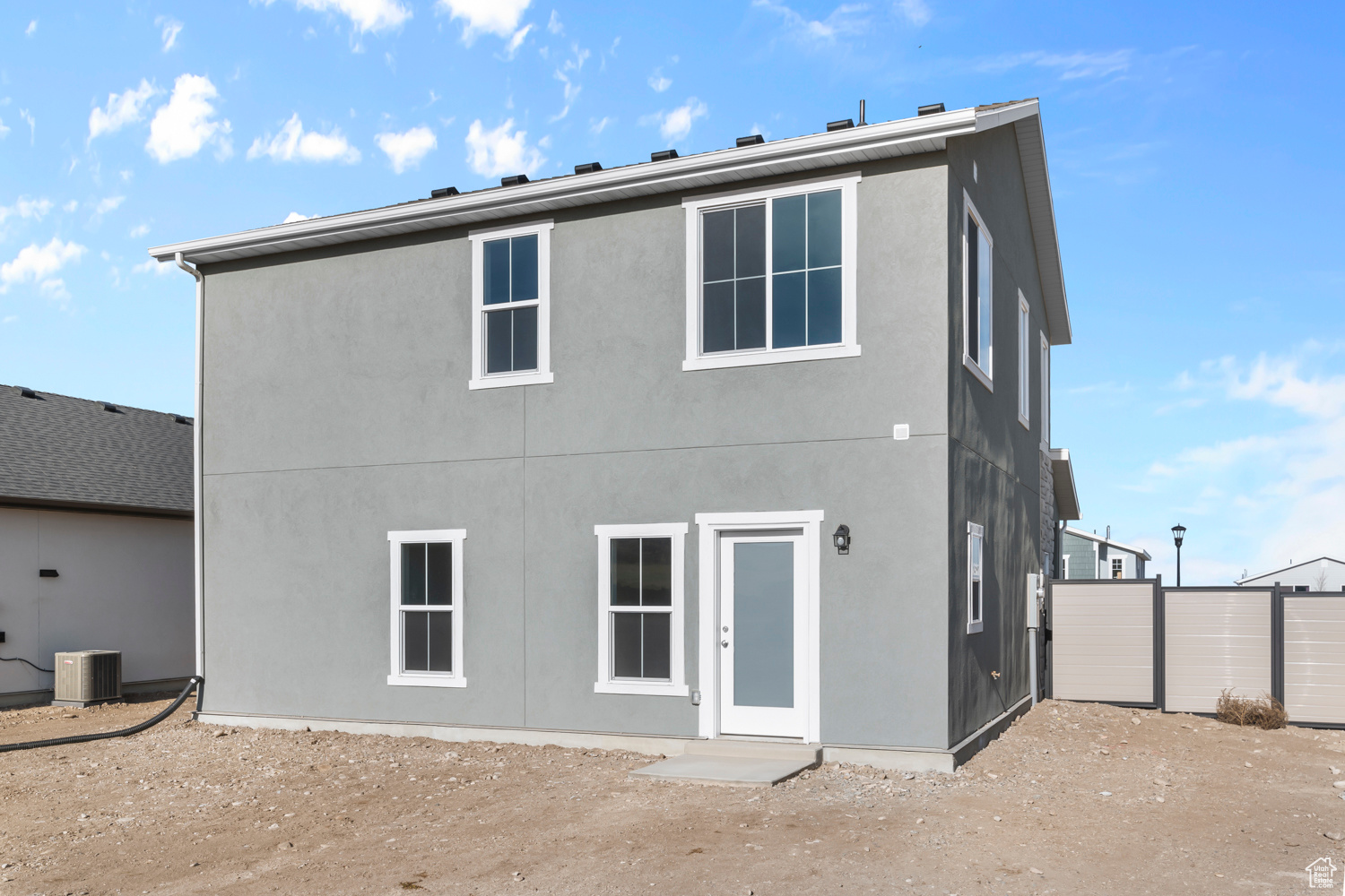 Rear view of house with cooling unit