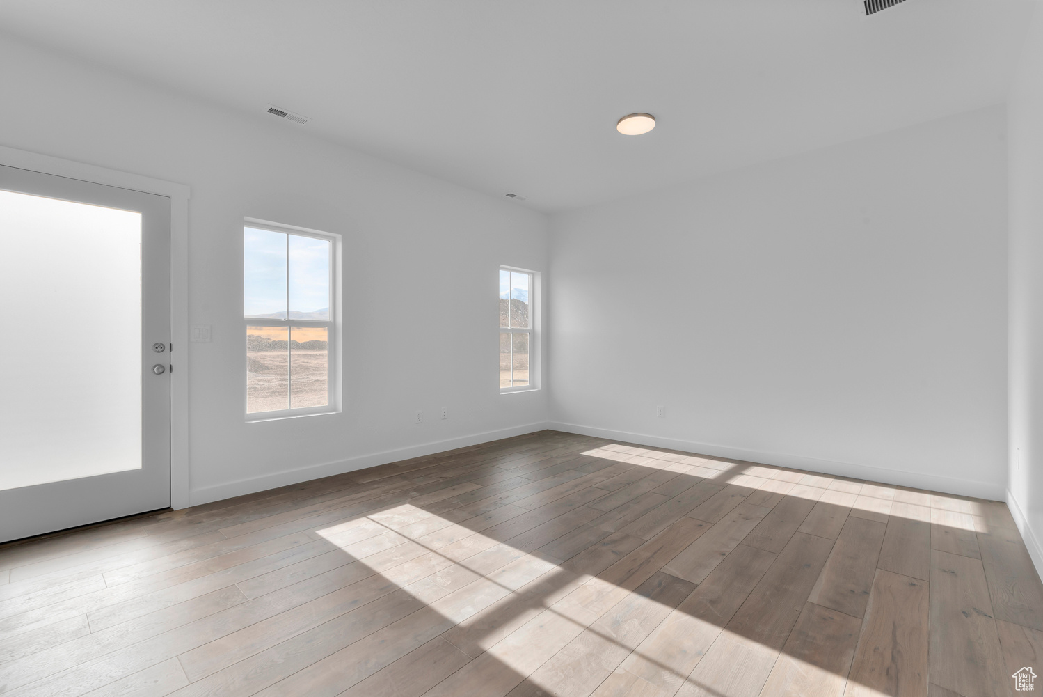 Unfurnished room with light hardwood / wood-style floors