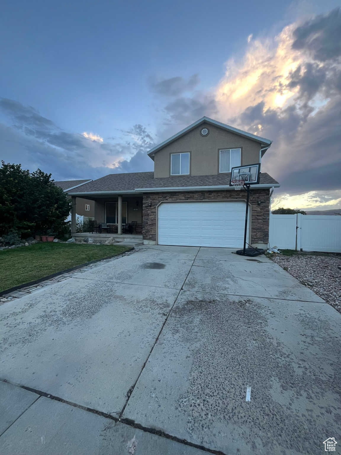 Front of property with a yard and a garage