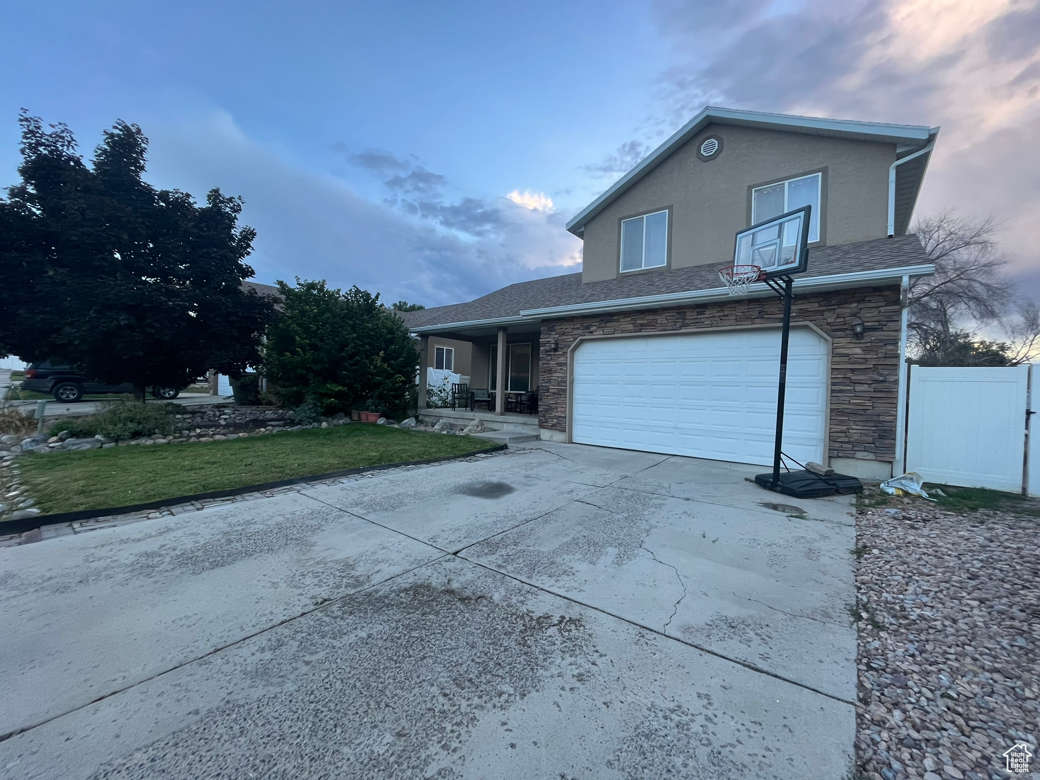 Front of property featuring a lawn and a garage