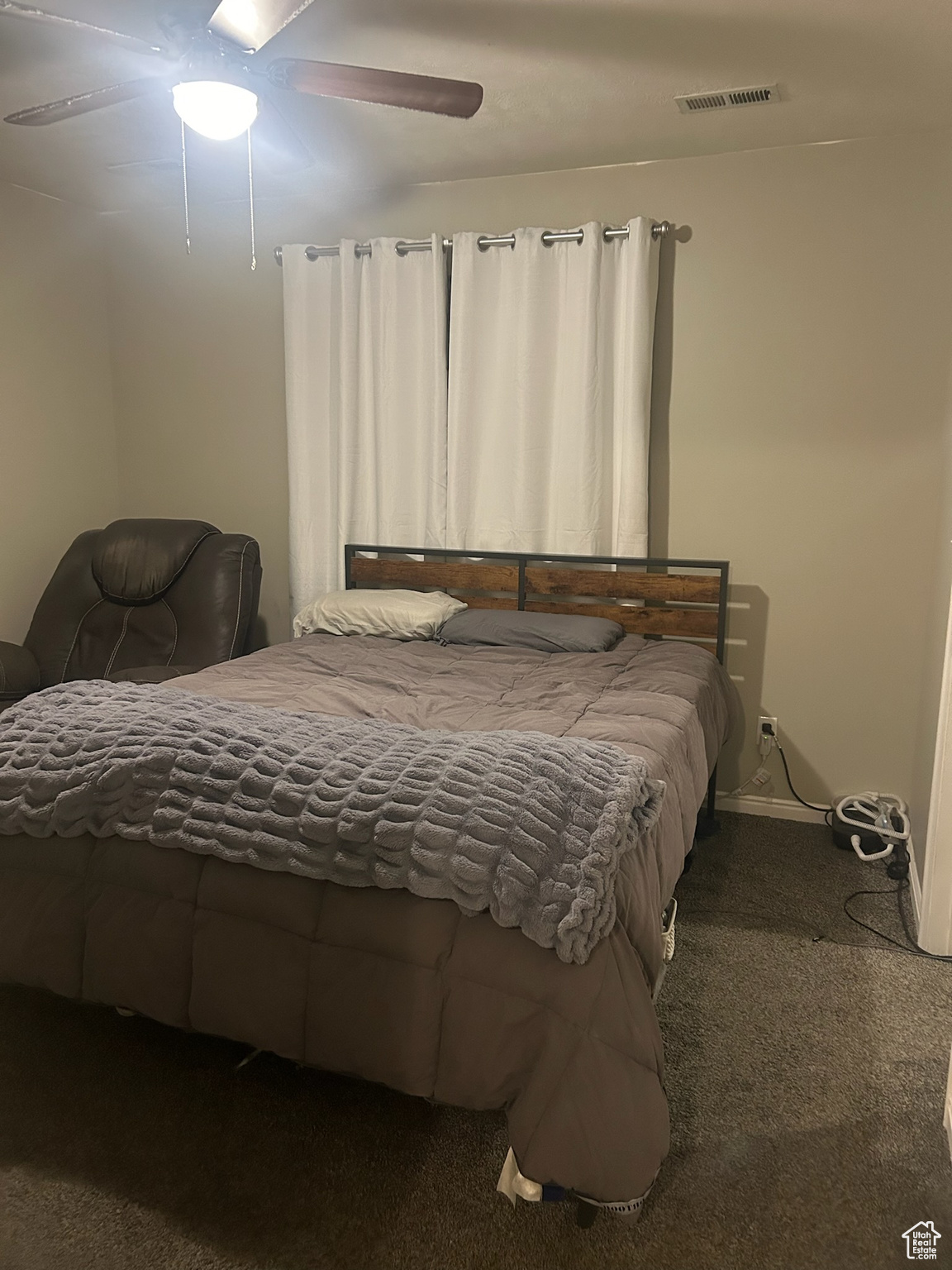 Bedroom with ceiling fan and carpet