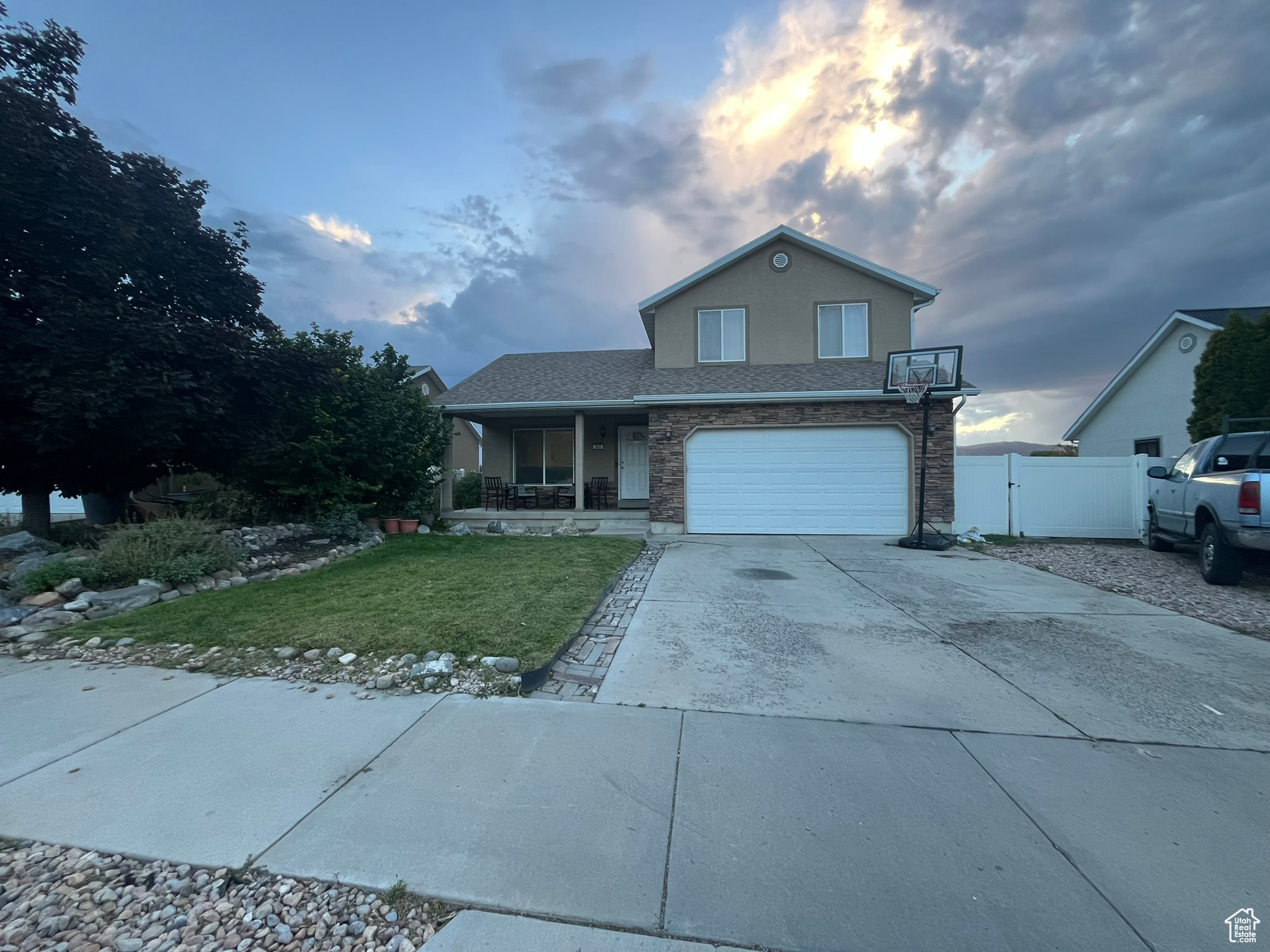 View of property featuring a lawn and a garage