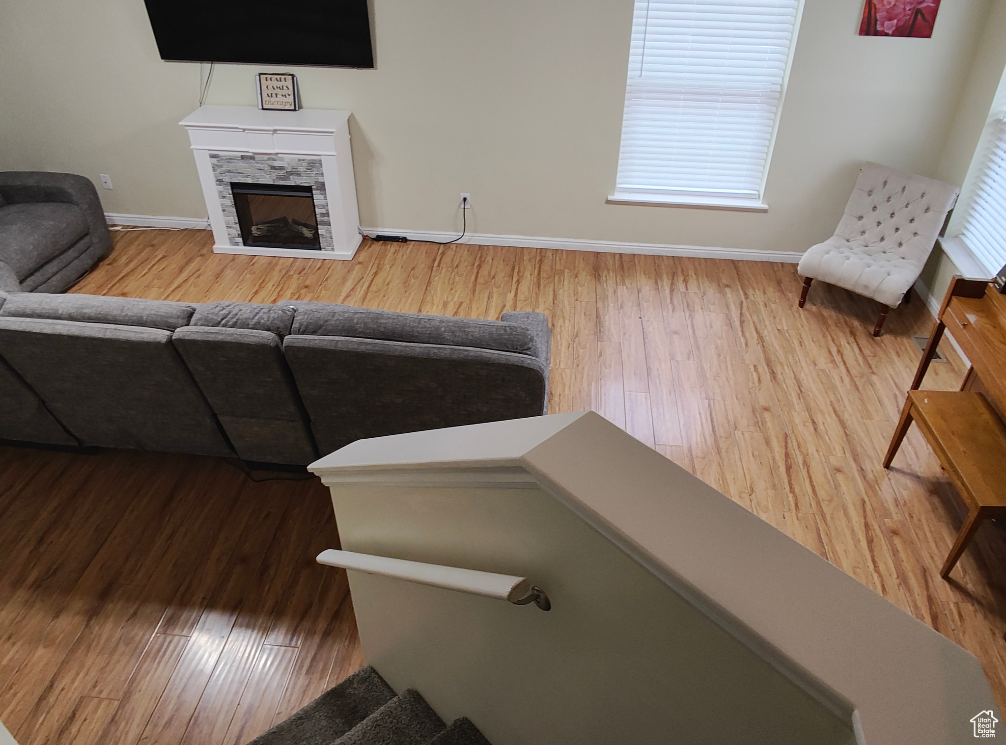 Living room featuring a wealth of natural light, a tile fireplace, and hardwood / wood-style flooring