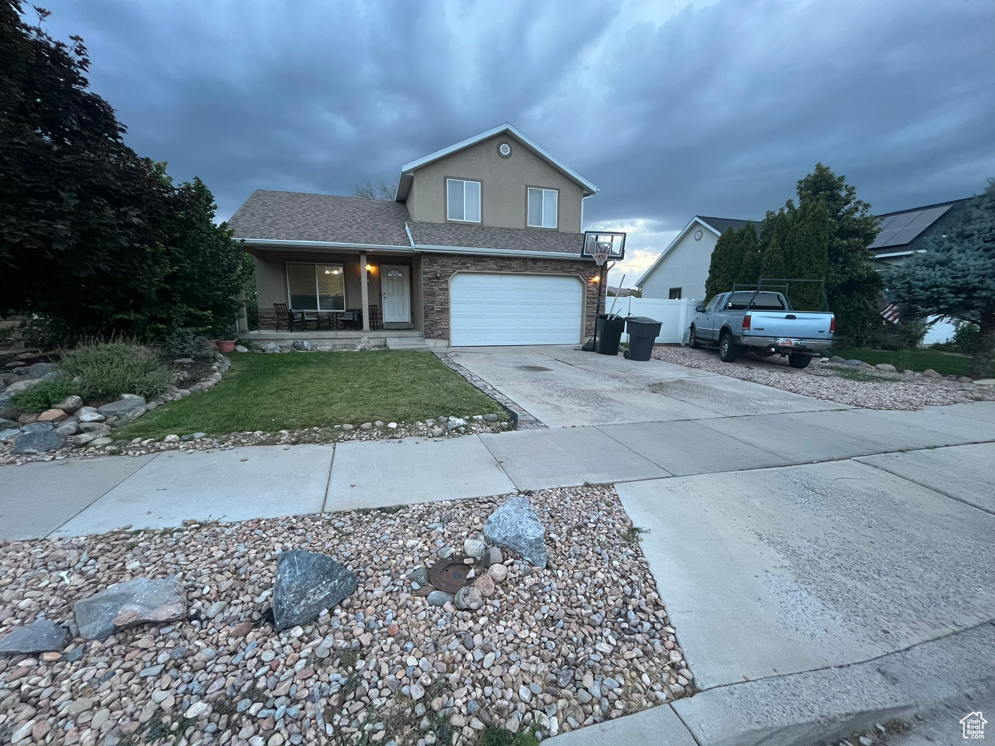 View of property featuring a garage and a porch