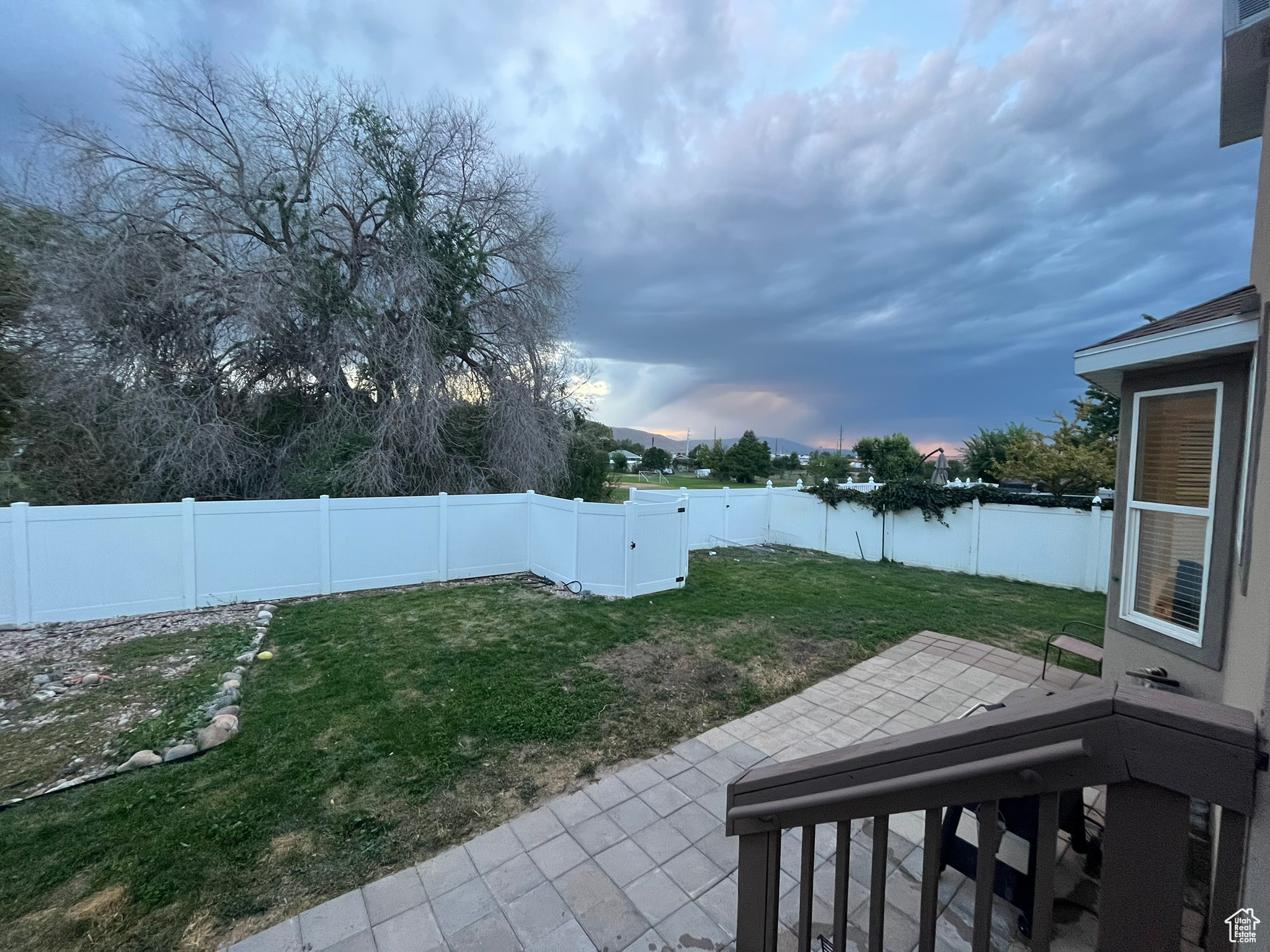 Yard at dusk with a patio area