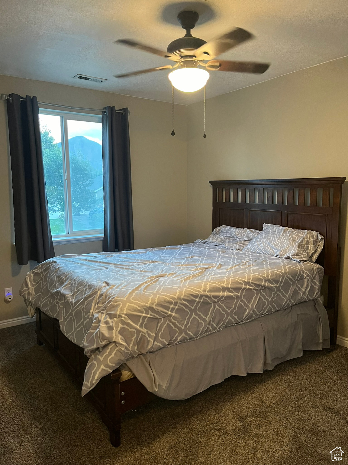 Carpeted bedroom with ceiling fan