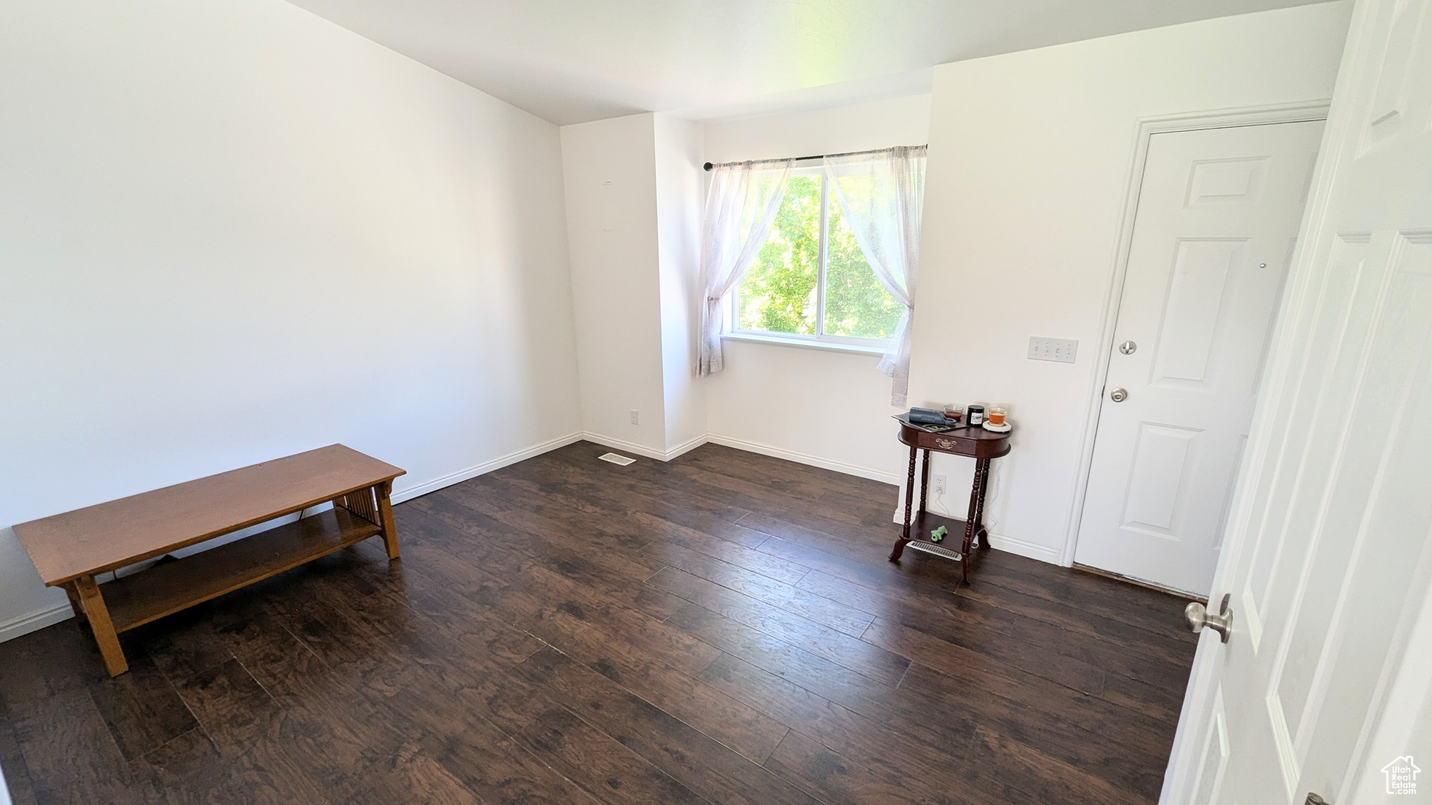 Unfurnished room featuring dark hardwood / wood-style flooring