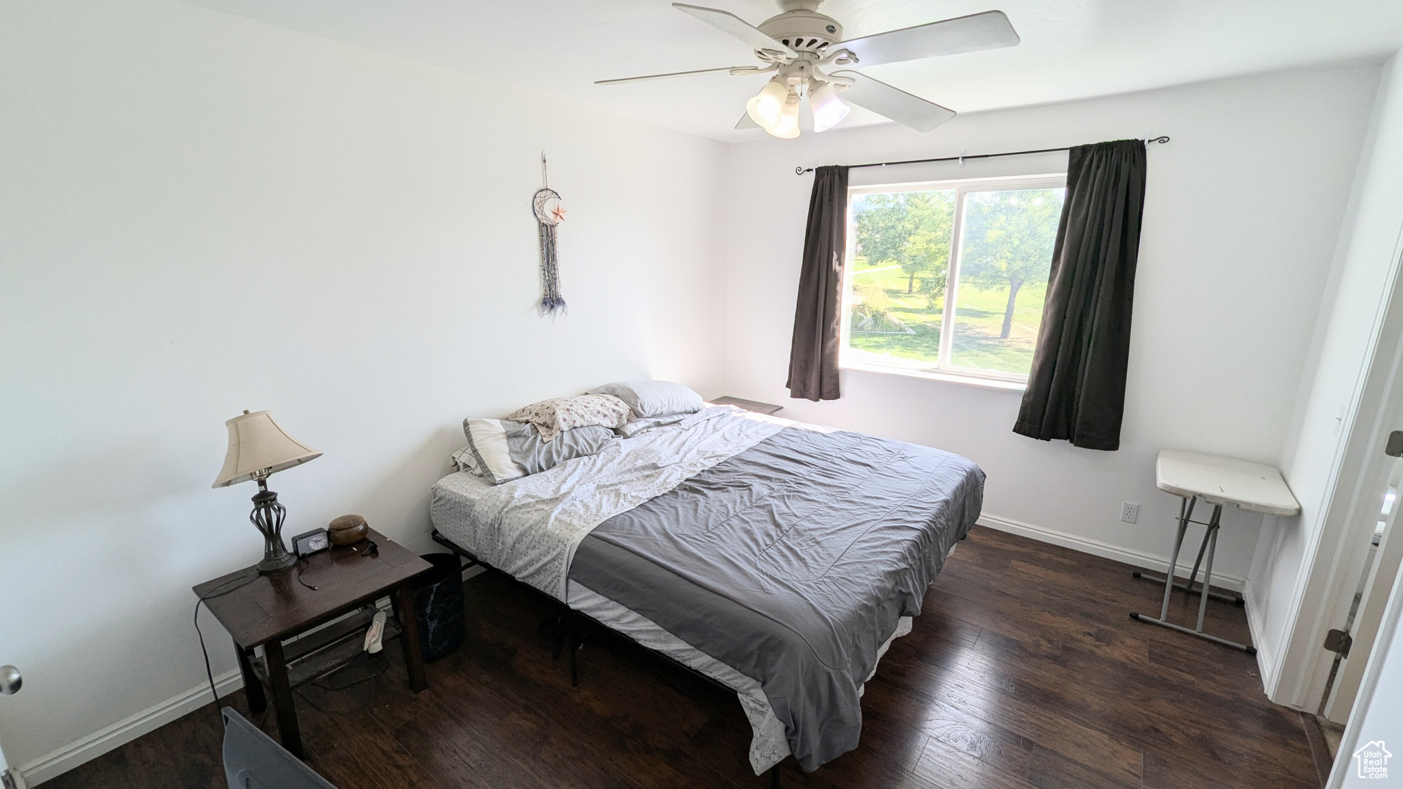 Bedroom with ceiling fan and dark hardwood / wood-style floors