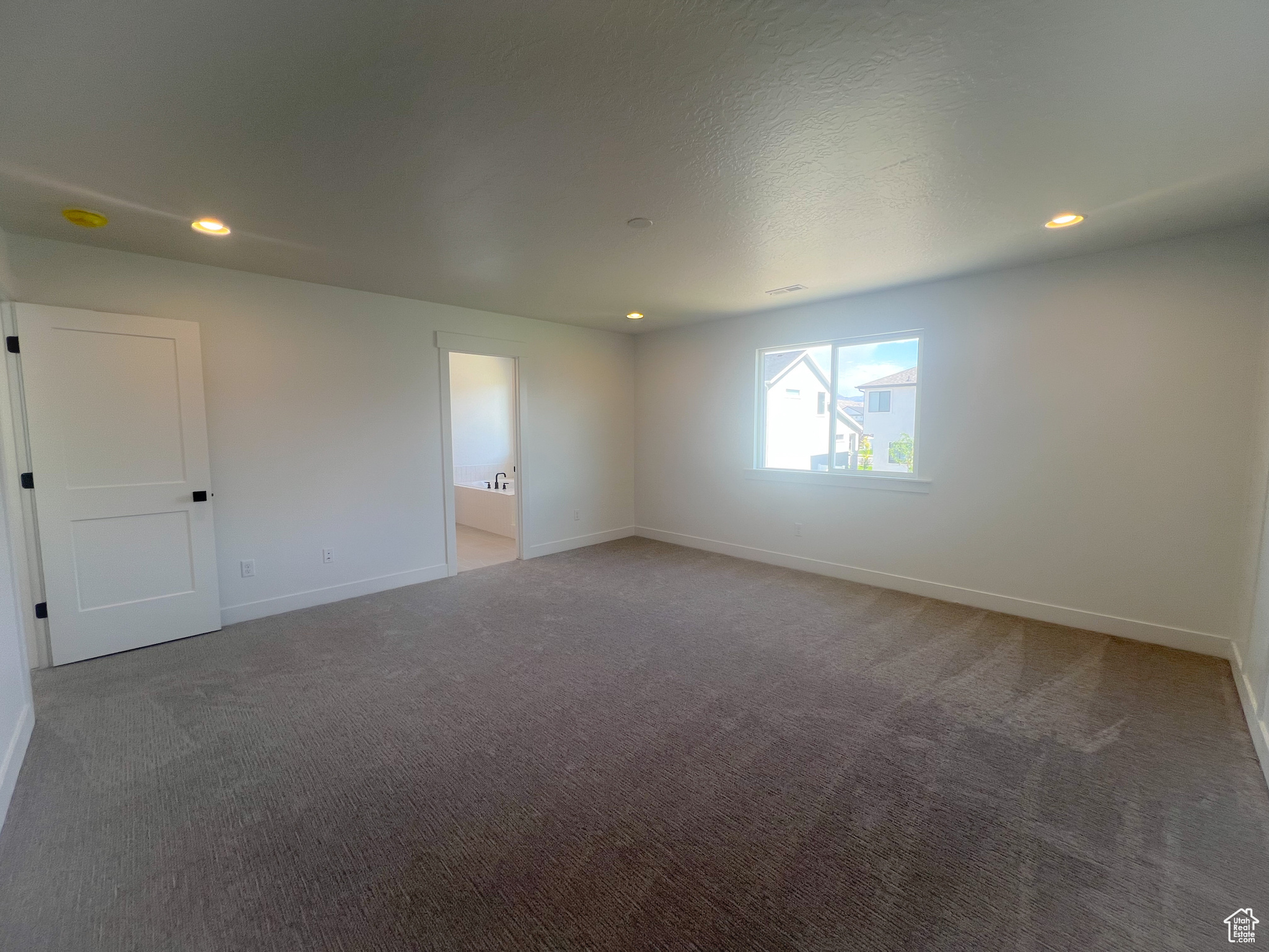 Spare room featuring carpet