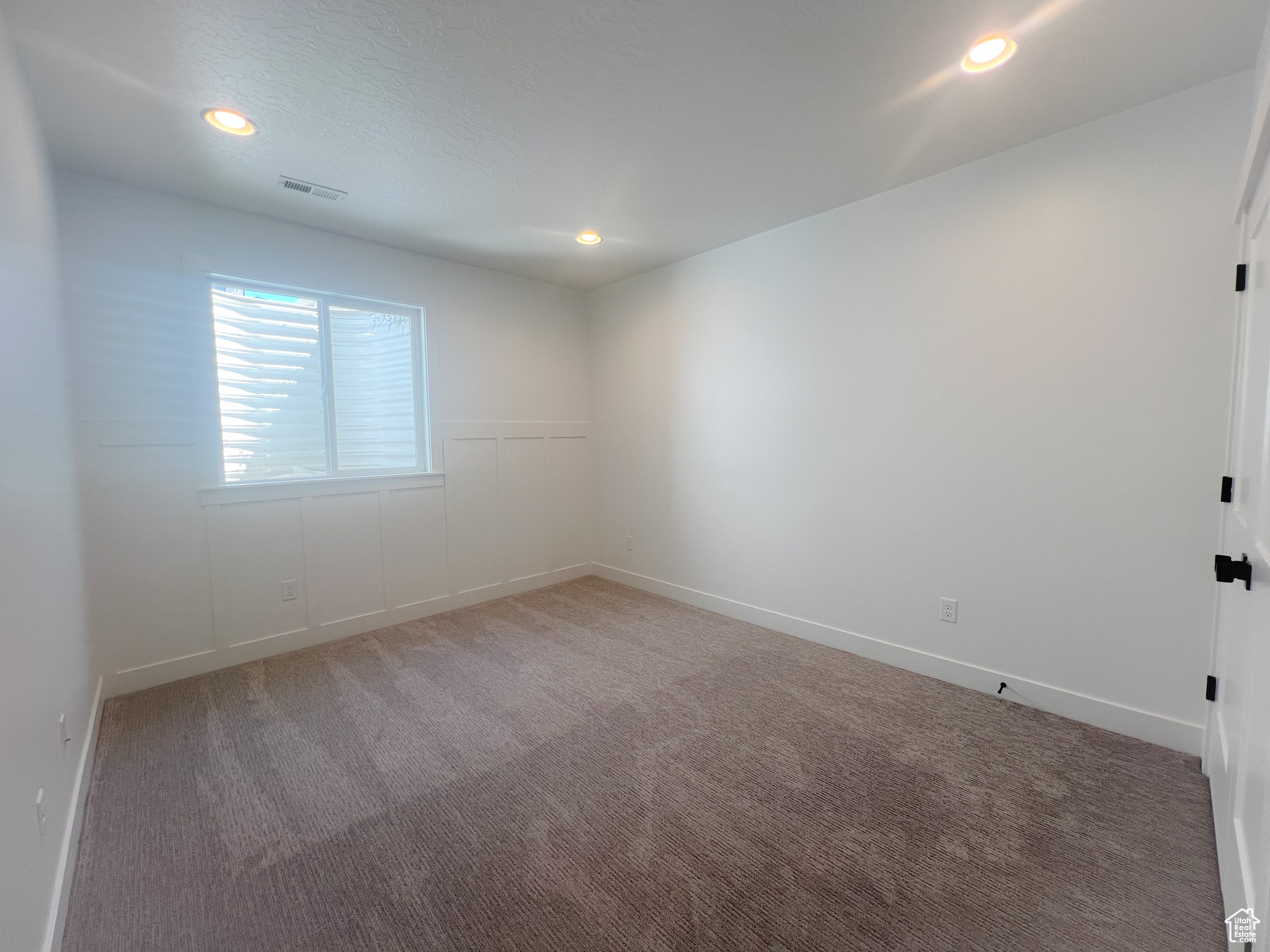 View of carpeted spare room