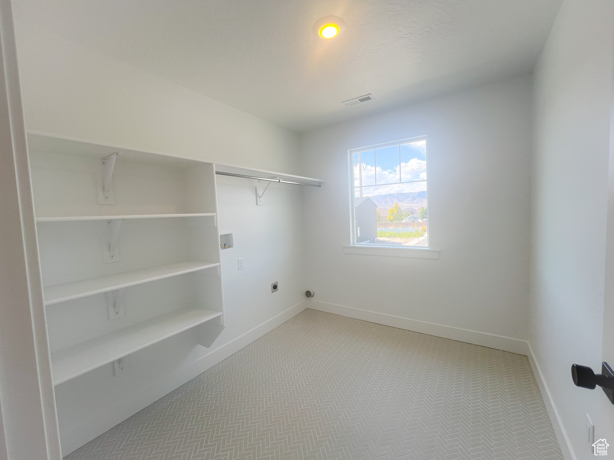 Walk in closet with carpet floors