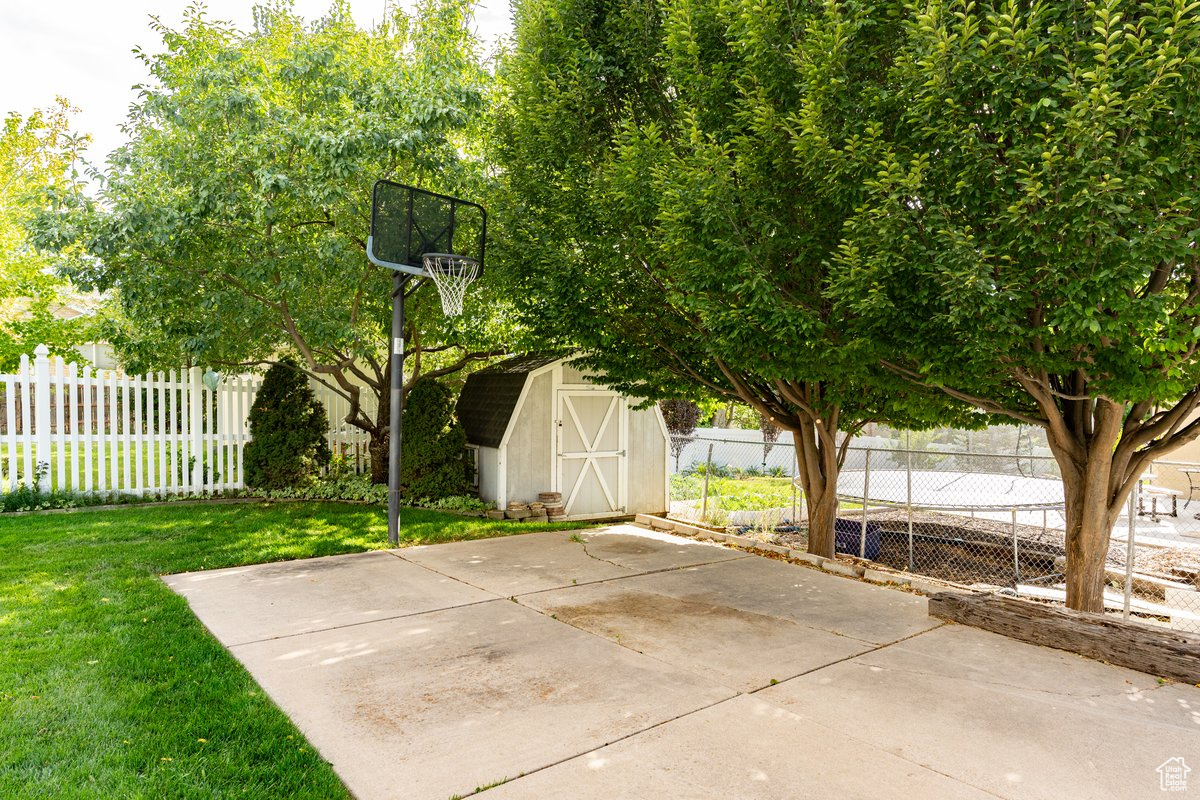 View of patio featuring a storage shed