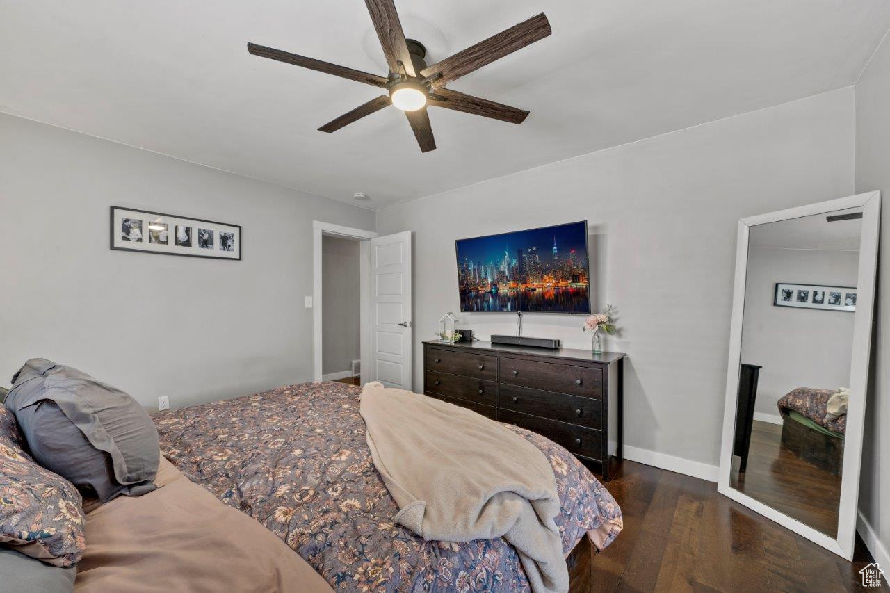 Bedroom with ceiling fan and dark hardwood / wood-style floors