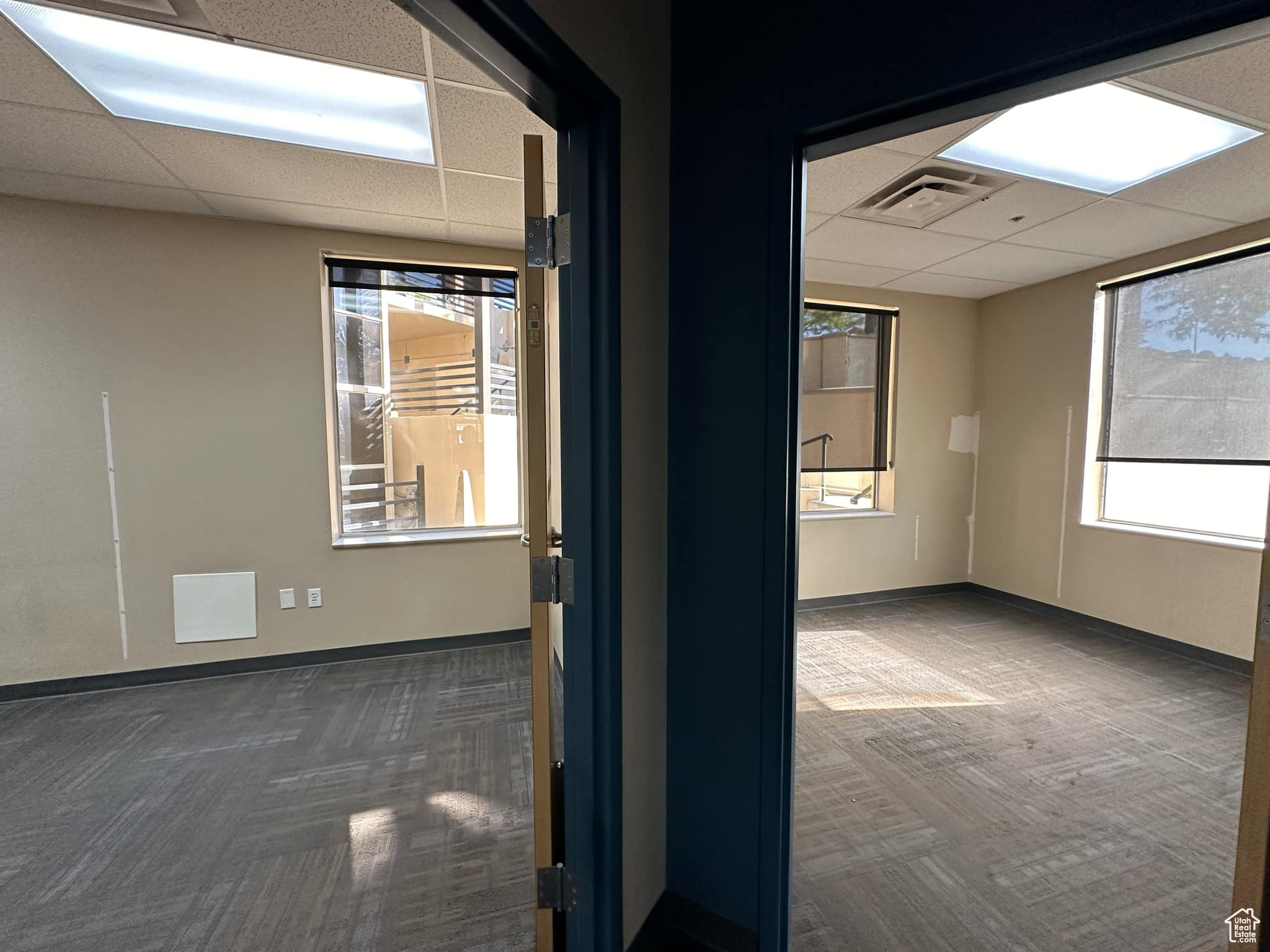 Carpeted spare room with a paneled ceiling