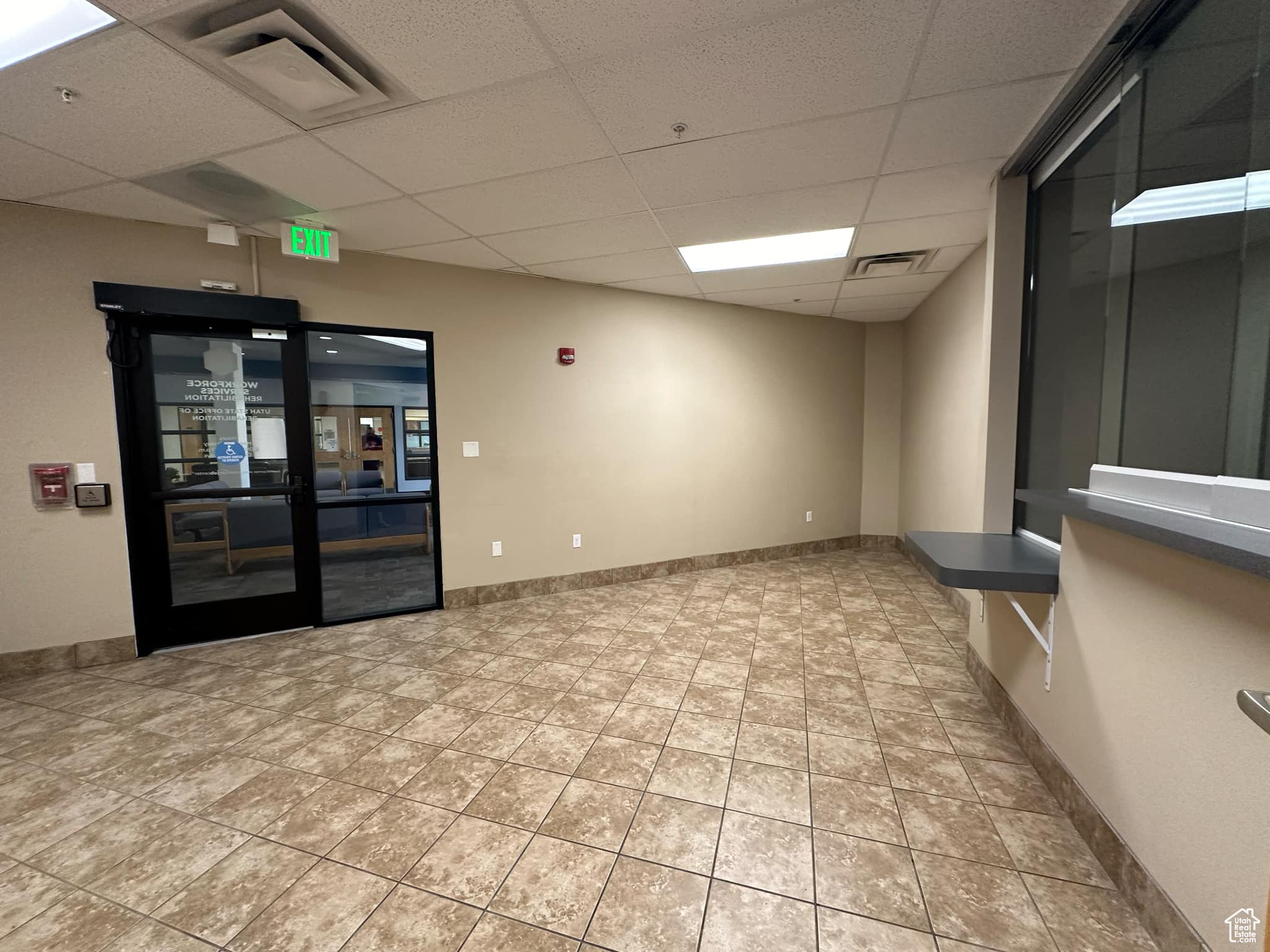 Empty room with a paneled ceiling