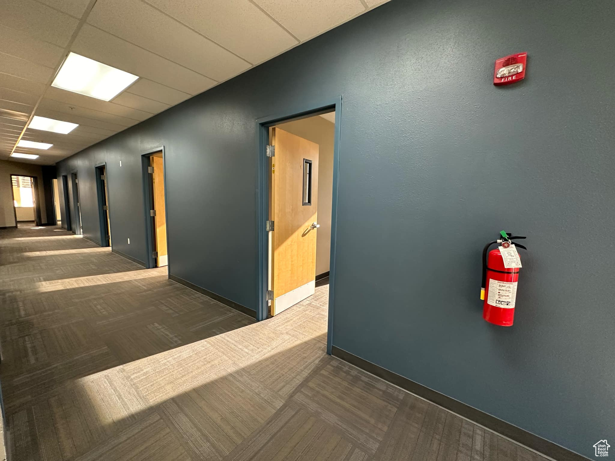 Corridor with a paneled ceiling