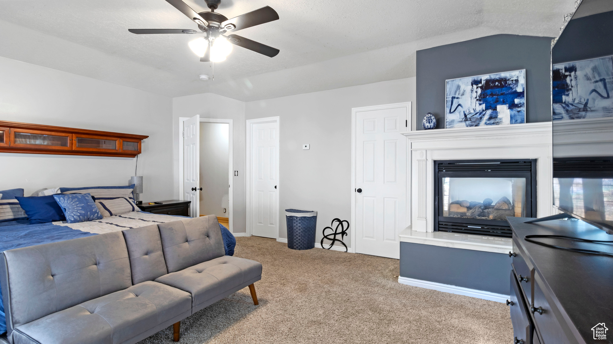 Bedroom with light carpet, lofted ceiling, and ceiling fan